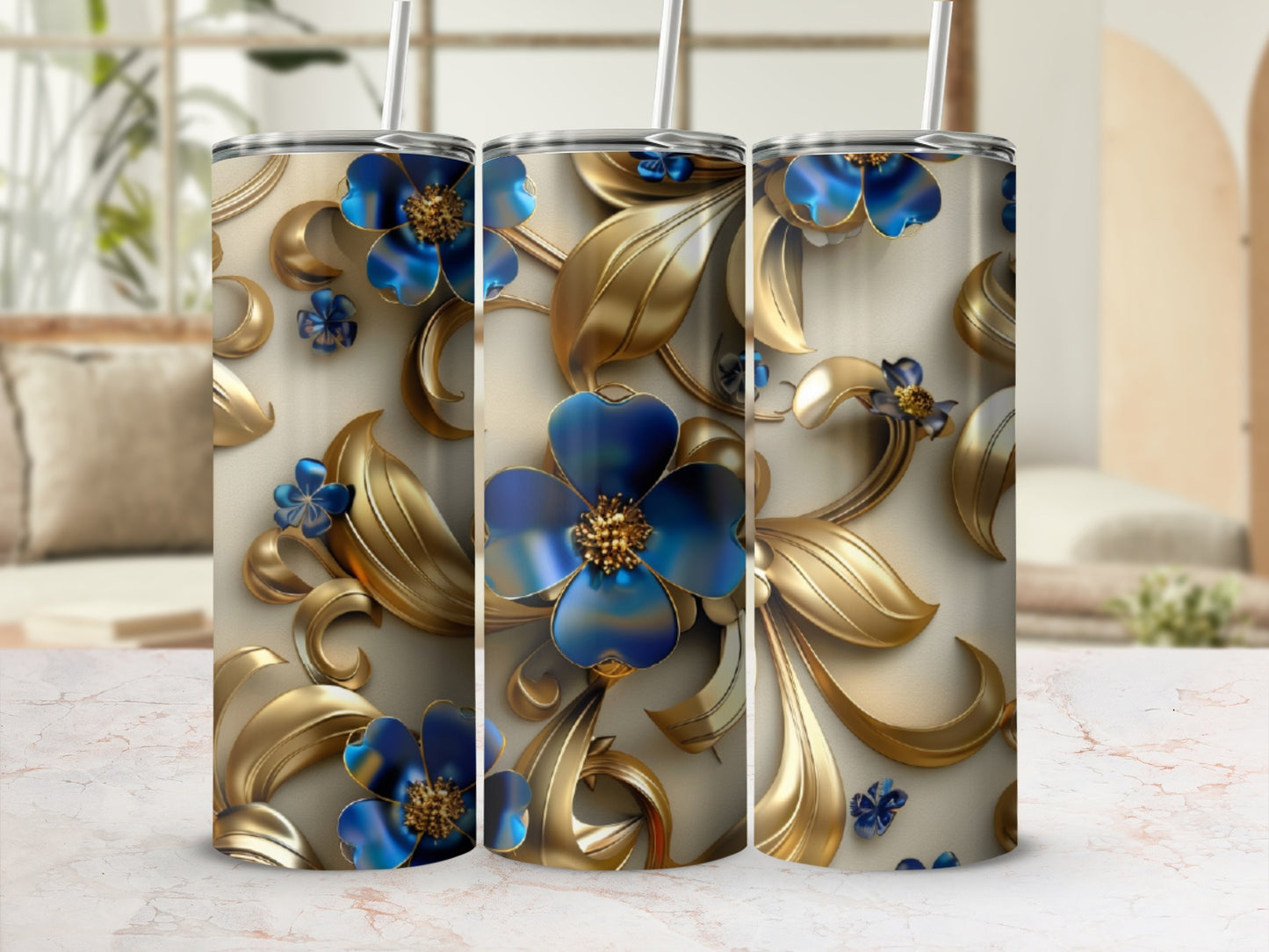 Three tumblers with blue flowers and gold leaves against a light background.