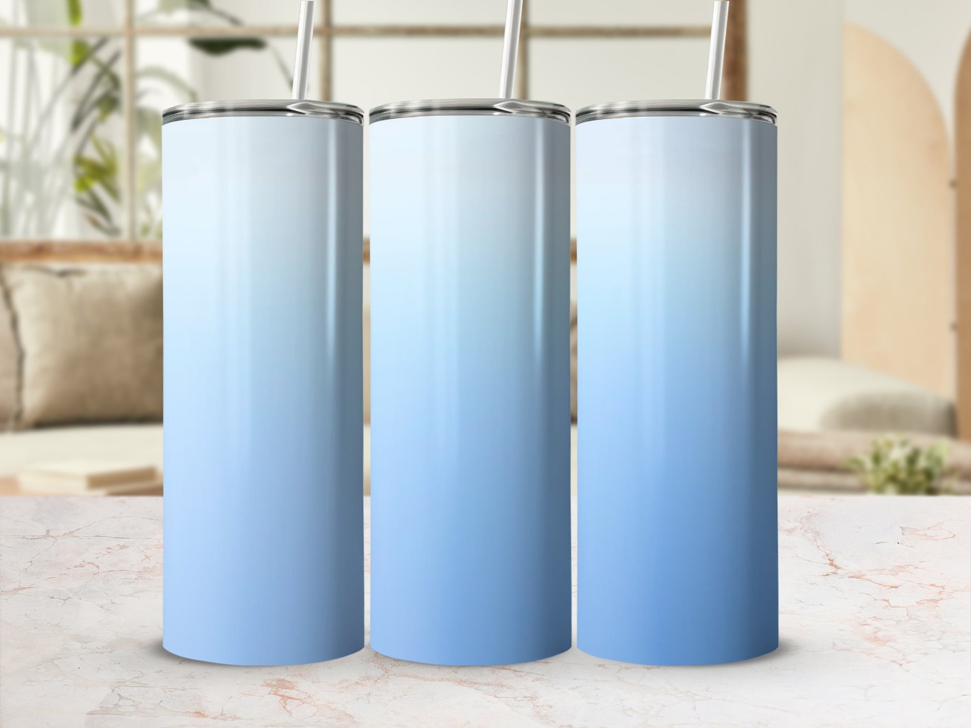 Three gradient tumblers with white lids and silver straws.