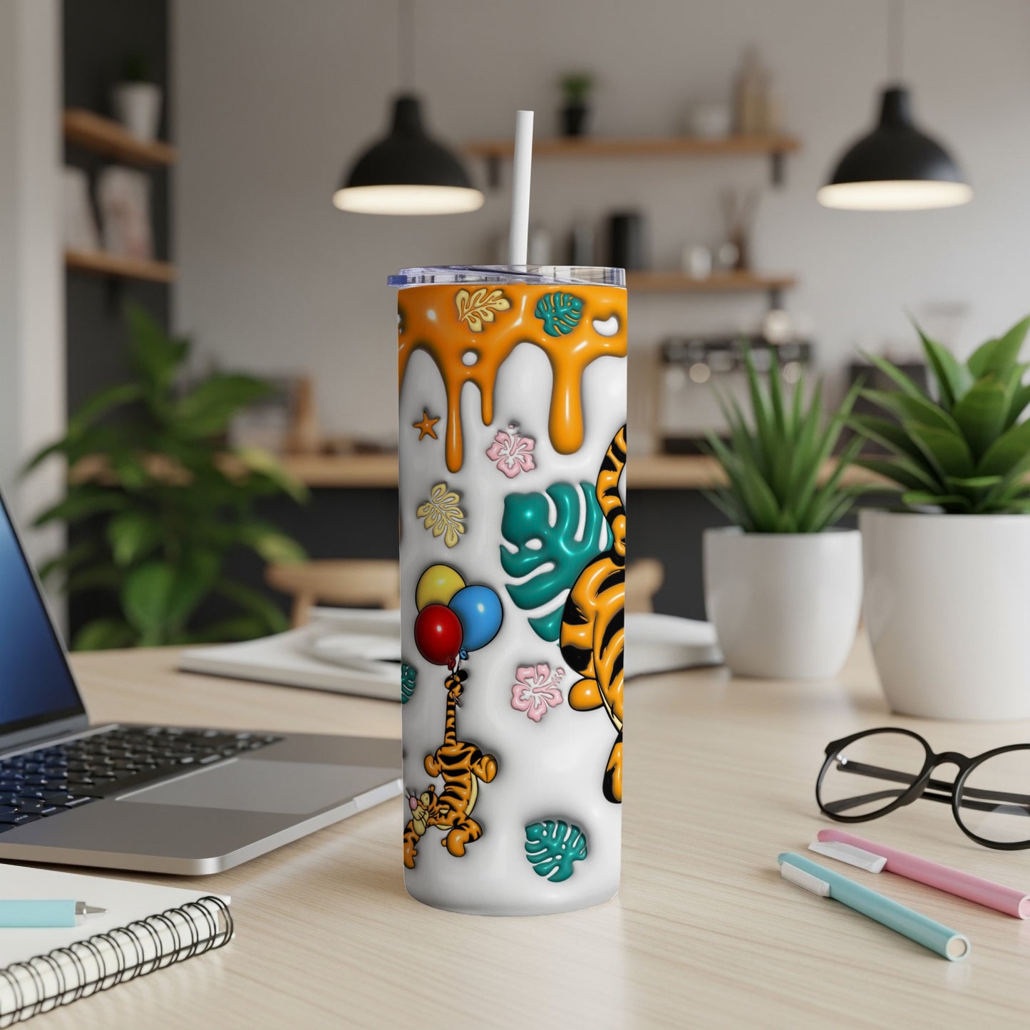 Tumbler with cartoon tigers, balloons, and orange dripping accents on white background.