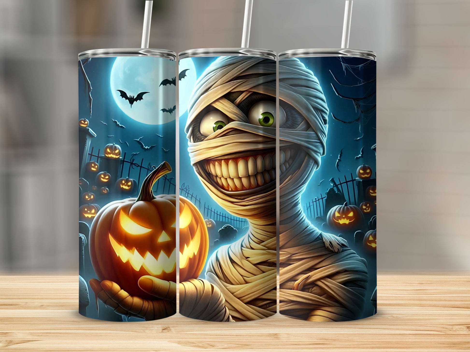 Halloween tumbler with mummy holding a jack-o'-lantern under a full moon.