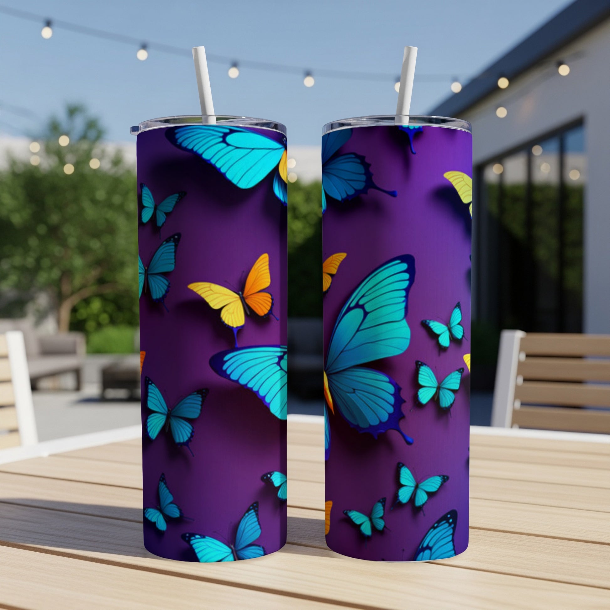 Two purple tumblers adorned with colorful butterflies and straws on a table.
