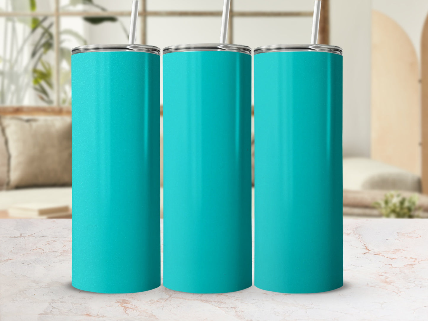 Three teal tumblers with straws on a marbled surface.