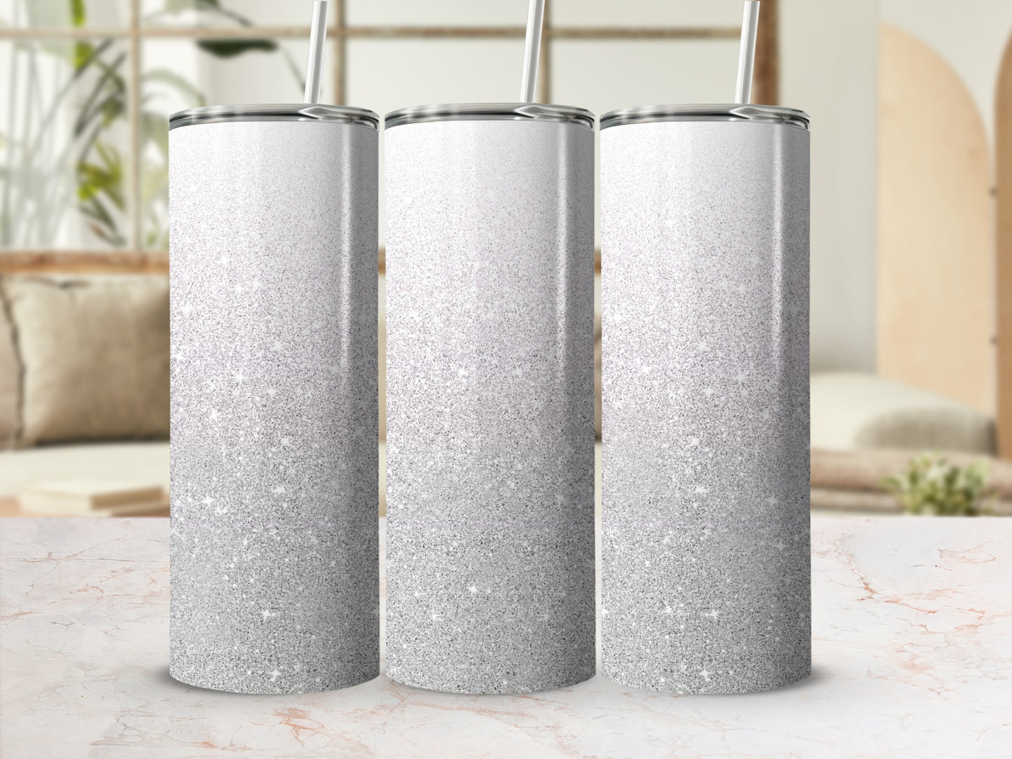 Three tall tumblers with silver glitter gradient and straw.