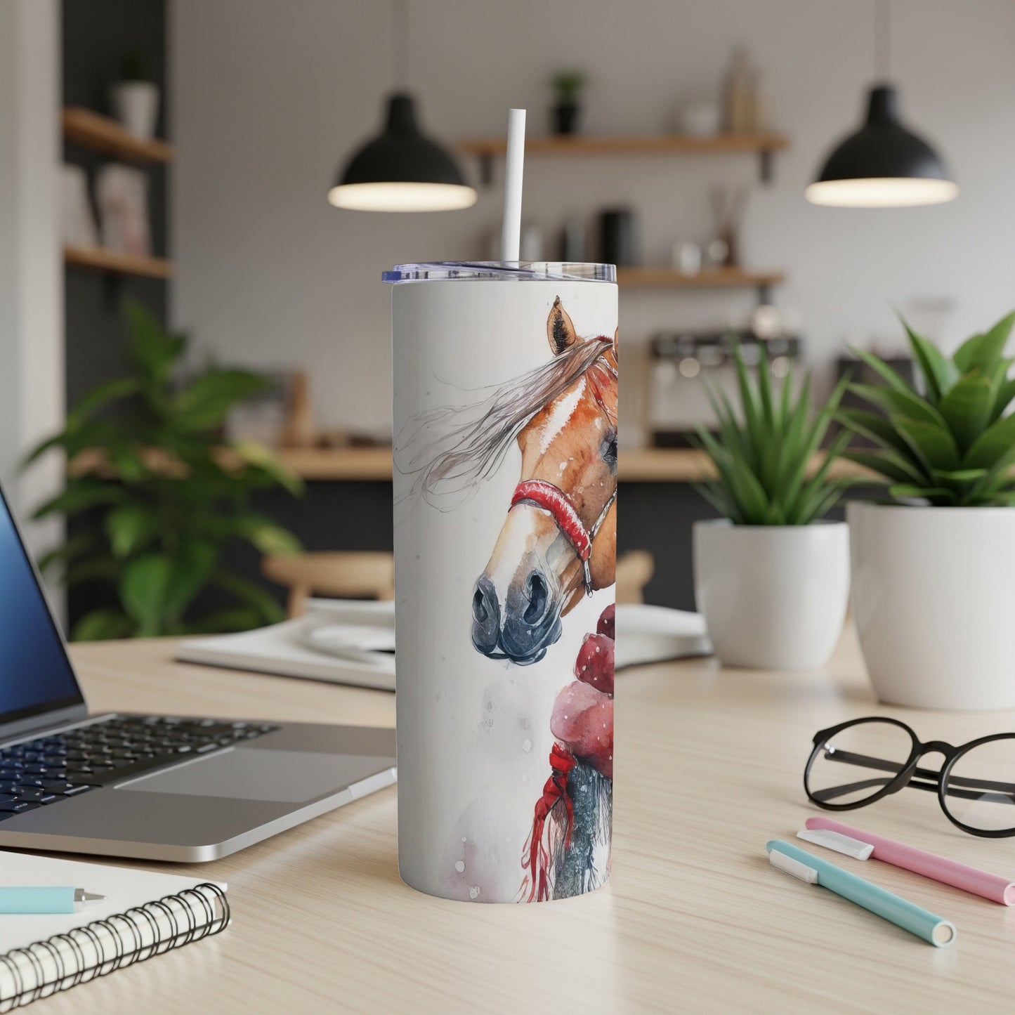 Tall tumbler with horse illustration, white lid, and straw on a desk.