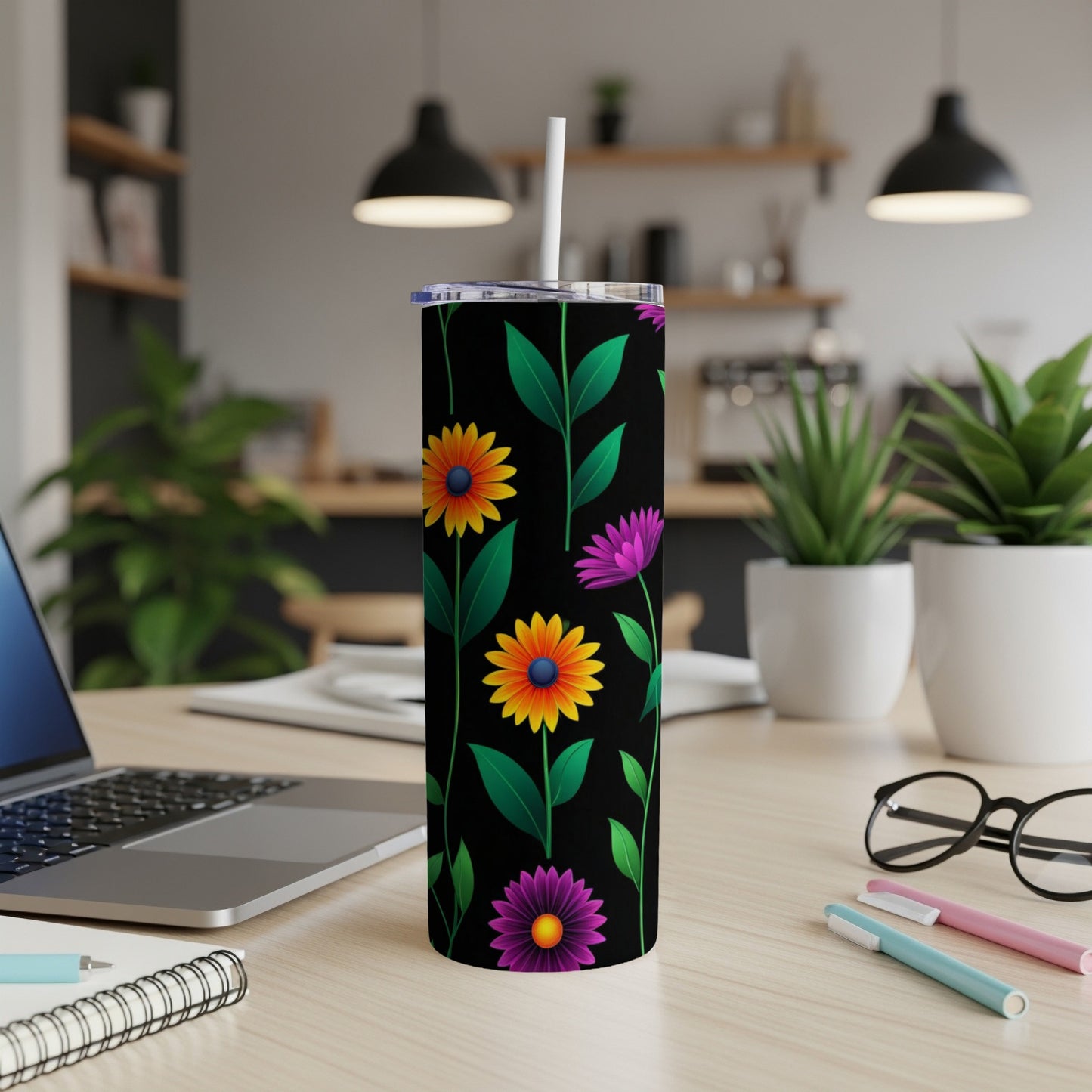 Black tumbler with a floral pattern of yellow and purple flowers.
