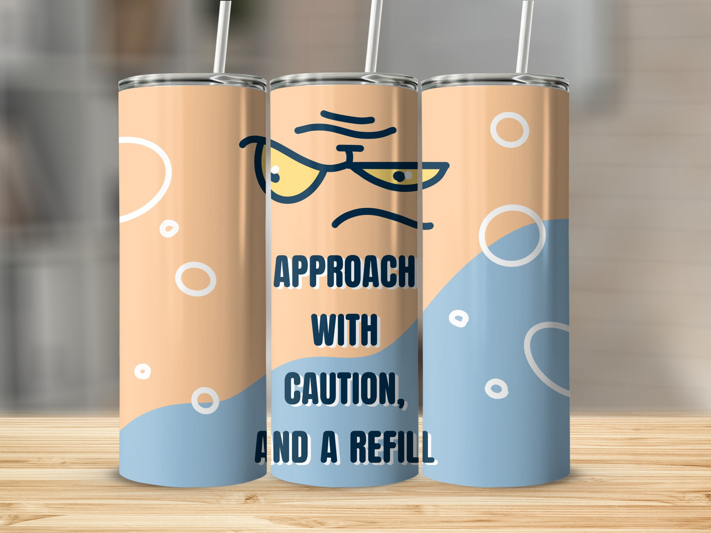 Three tumblers with a grumpy face and "Approach with caution, and a refill" text.