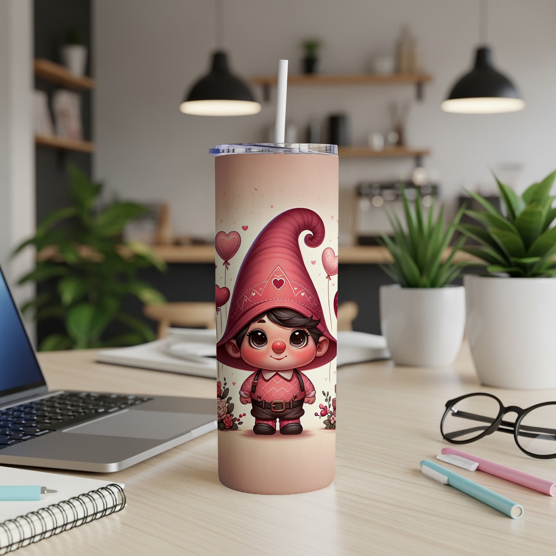 Cute gnome tumbler with hearts and red hat on a desk.