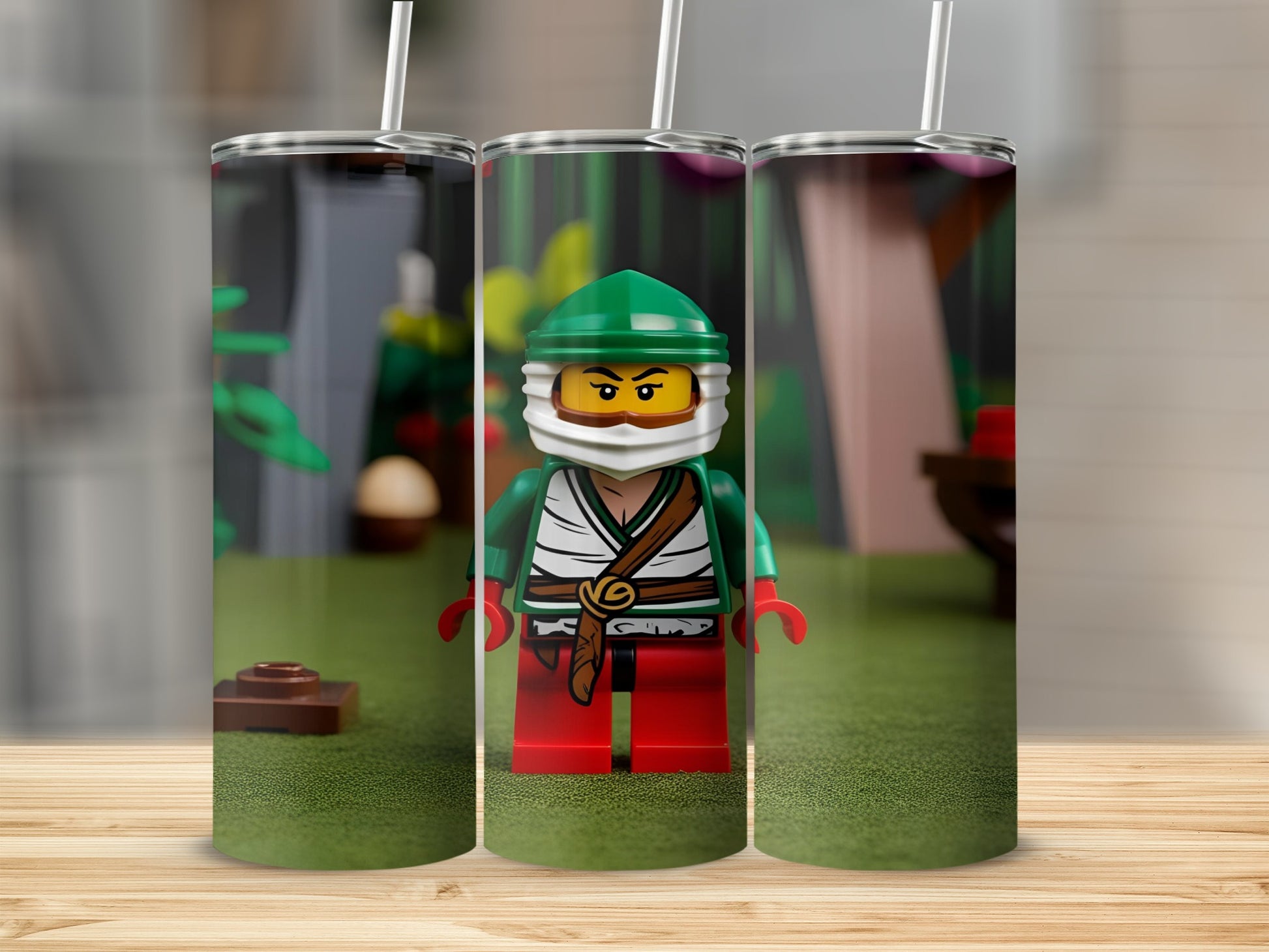 Three tumblers with a Lego minifigure in green and red attire.