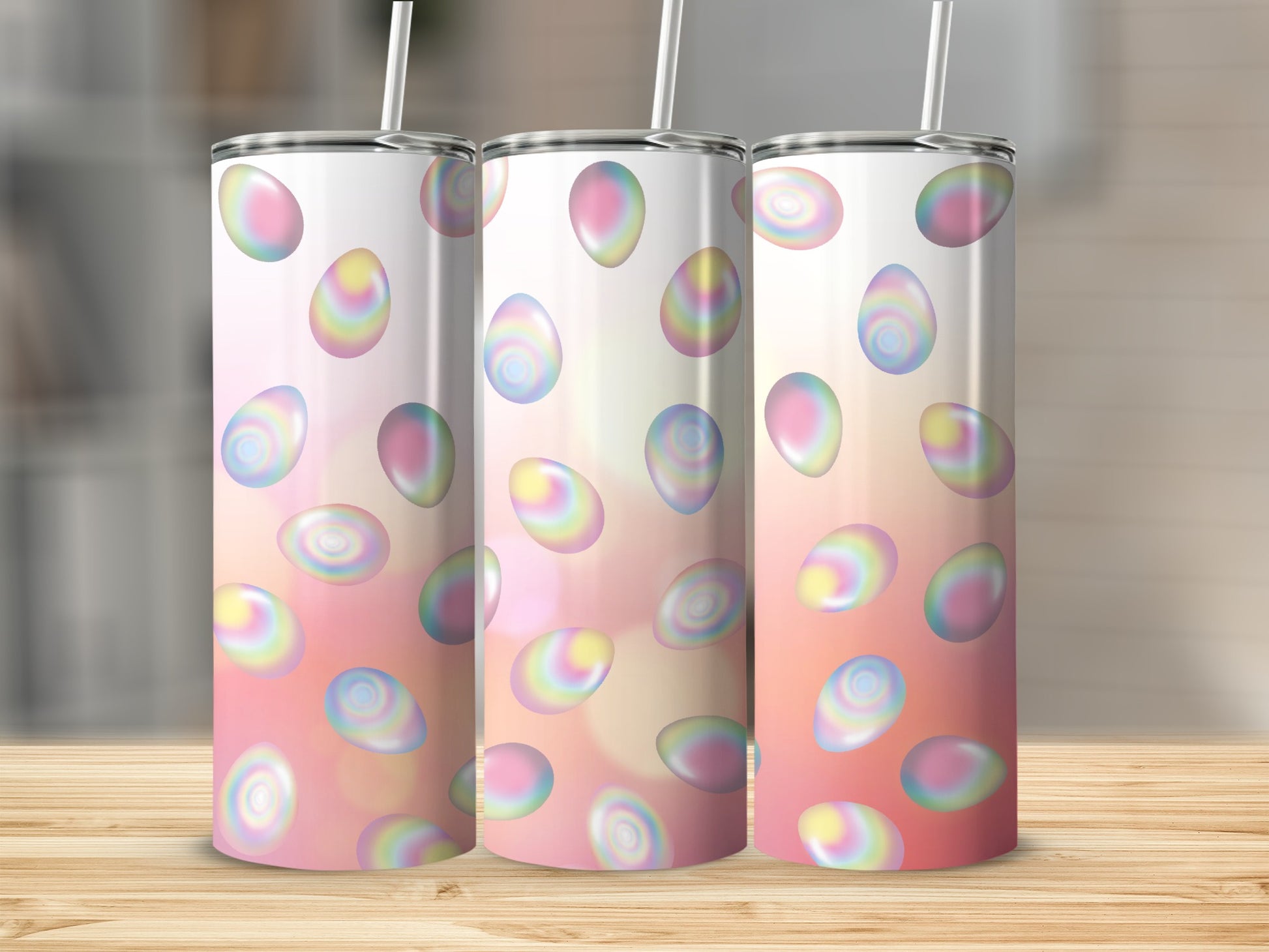 Three tumblers with pastel Easter eggs on a light pink gradient background.