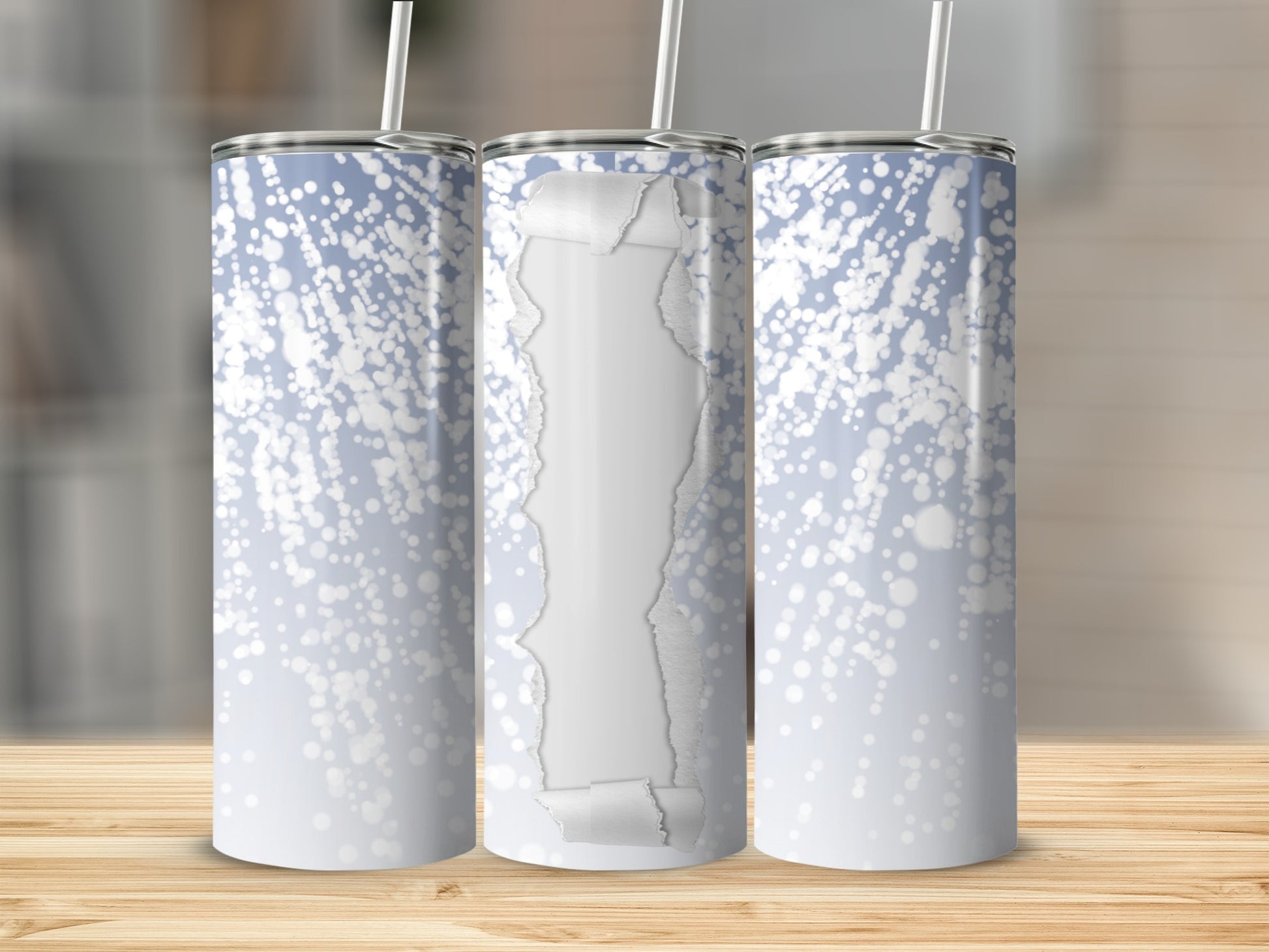 Torn paper revealing blue and white glitter pattern on a tumbler.