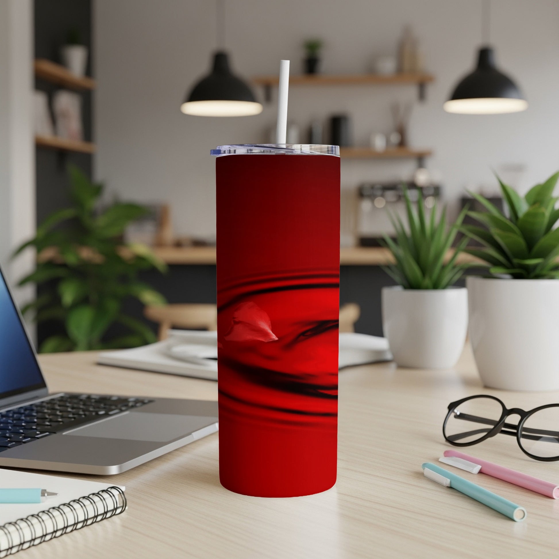 Red abstract swirl pattern on a stainless steel tumbler with a straw.