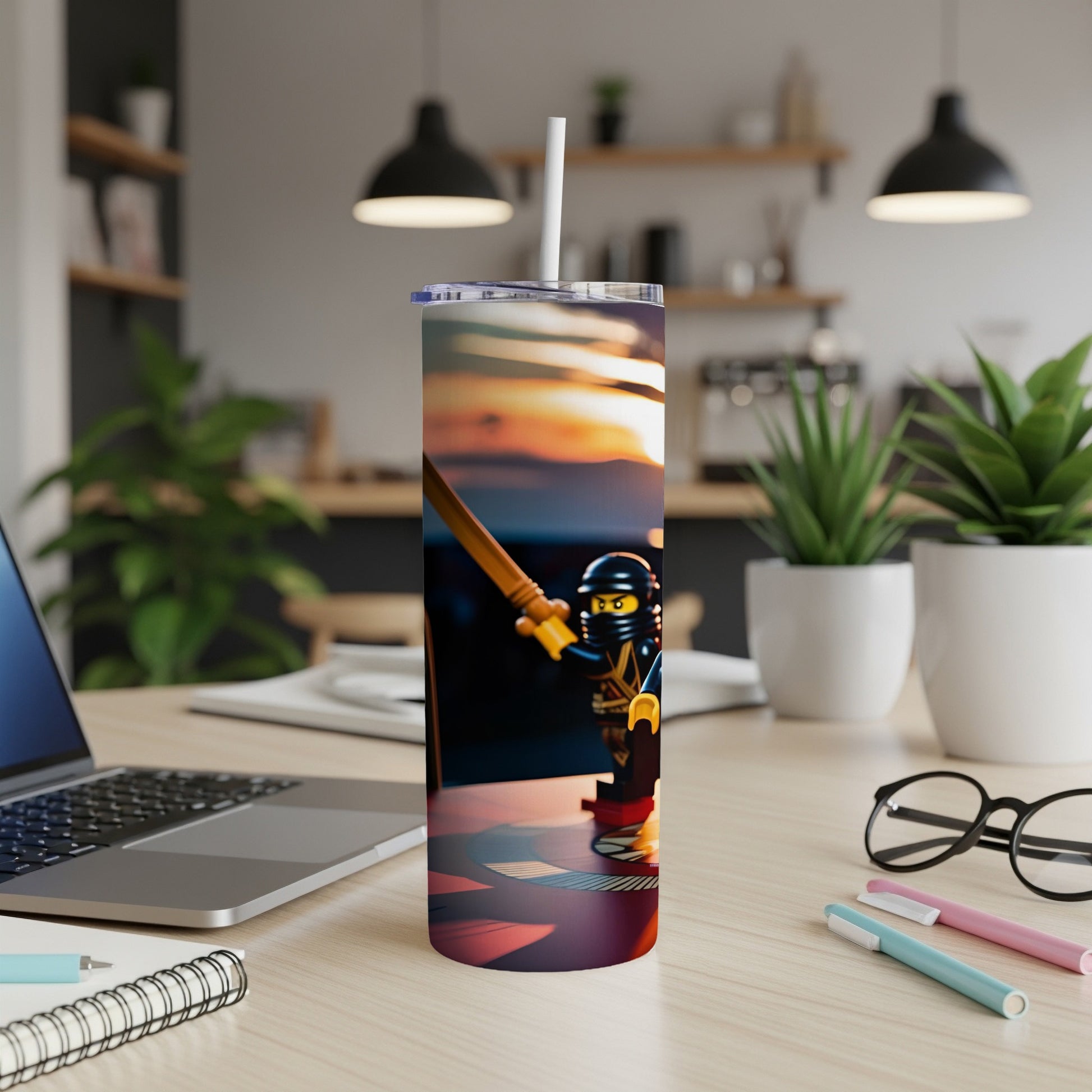 Ninja toy figure on a colorful tumbler with straw, desktop background.