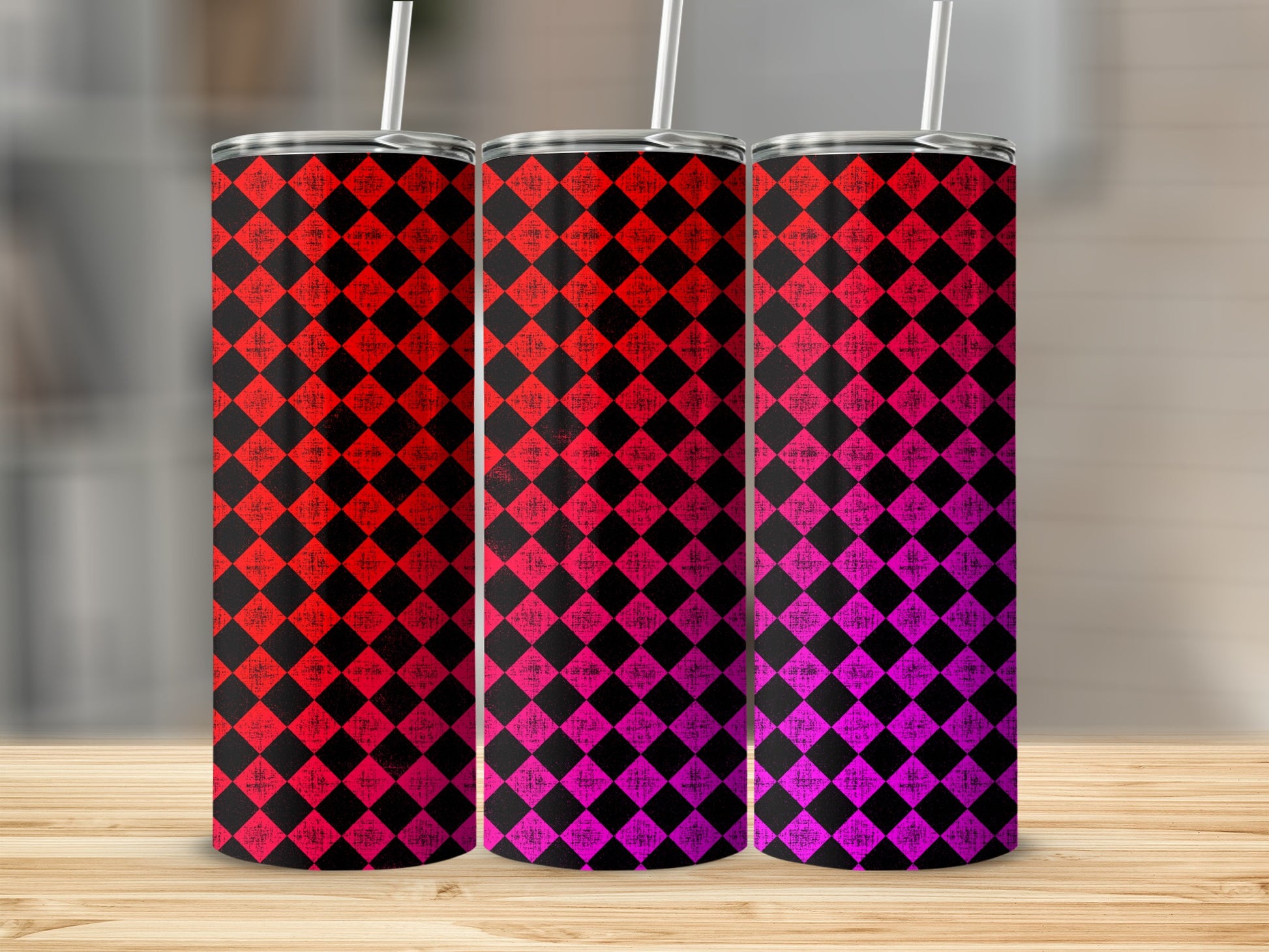 Three tumblers with red and pink diamond patterns and straws.