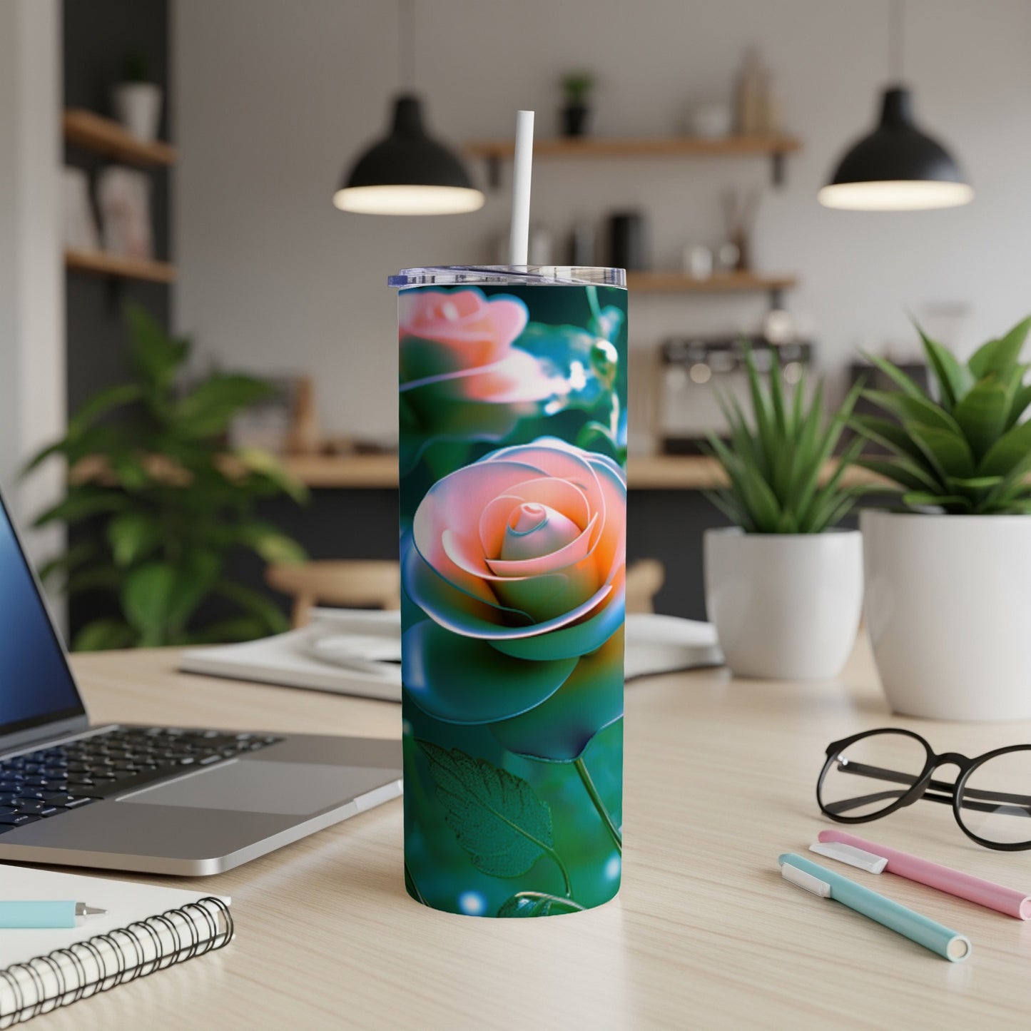 Tumbler with a glowing pink and orange rose design on a wooden desk.