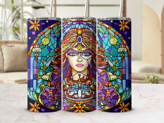 Stained glass tumbler with a woman's face surrounded by floral and celestial motifs.