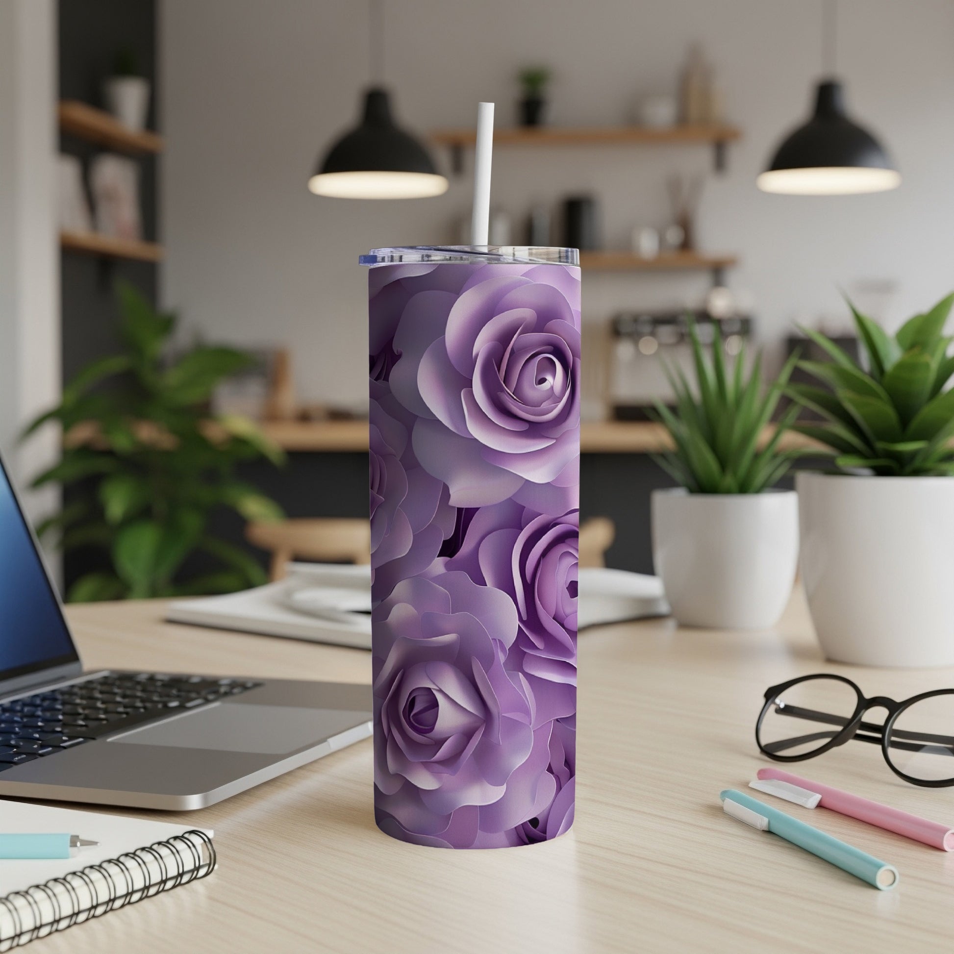 Purple floral patterned tumbler with a white straw on a wooden desk.