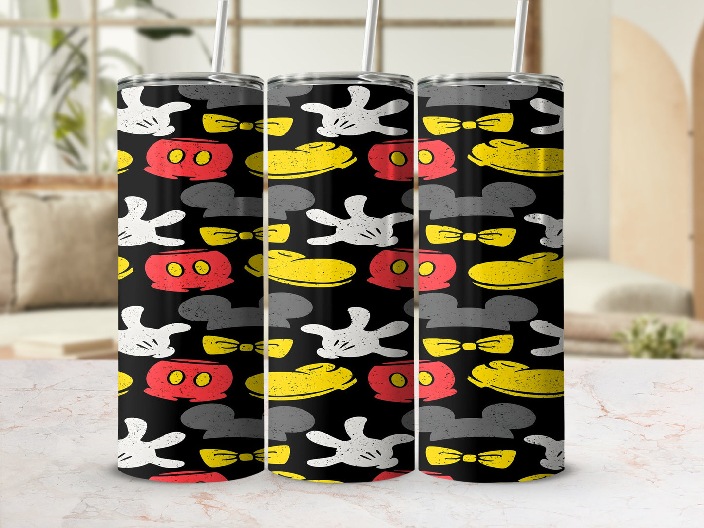 Three tumblers with a repeating Mickey Mouse glove, bow, and ear pattern.