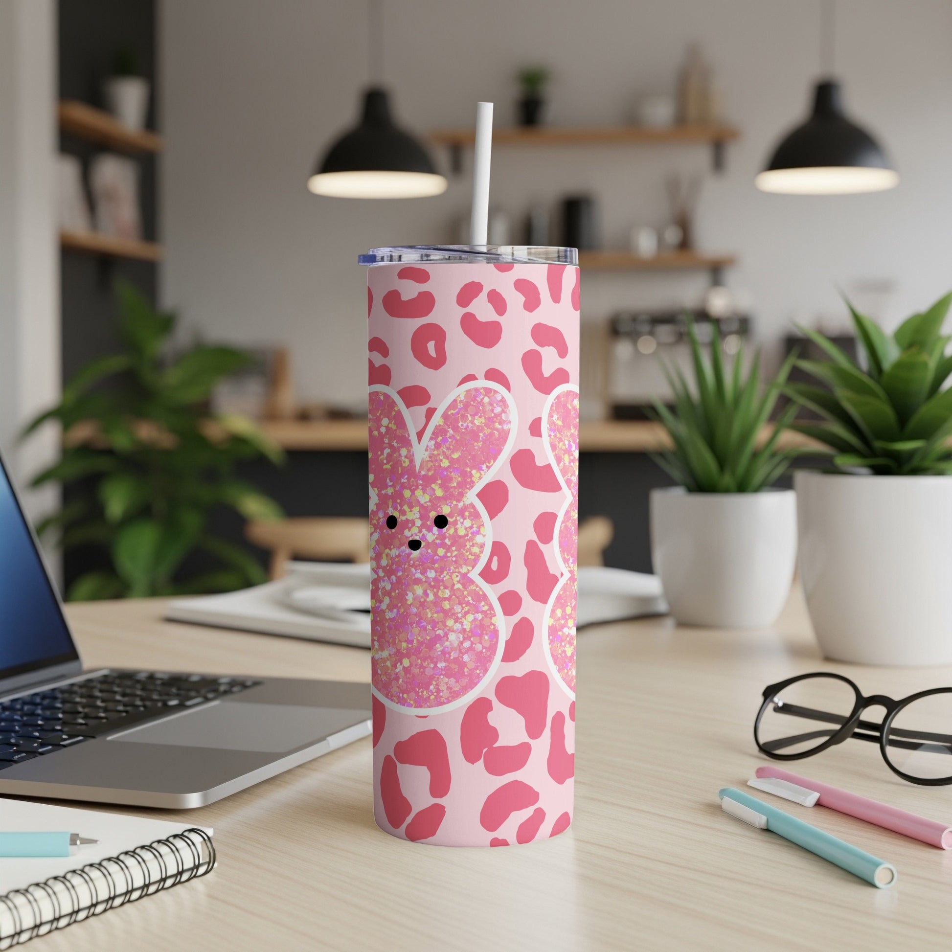 Pink tumbler with white bunny outline filled with glitter and leopard print.