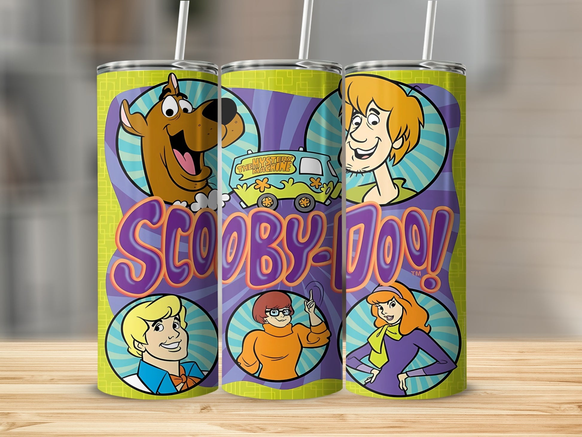 Scooby-Doo characters and Mystery Machine on a green, purple, and yellow patterned tumbler.