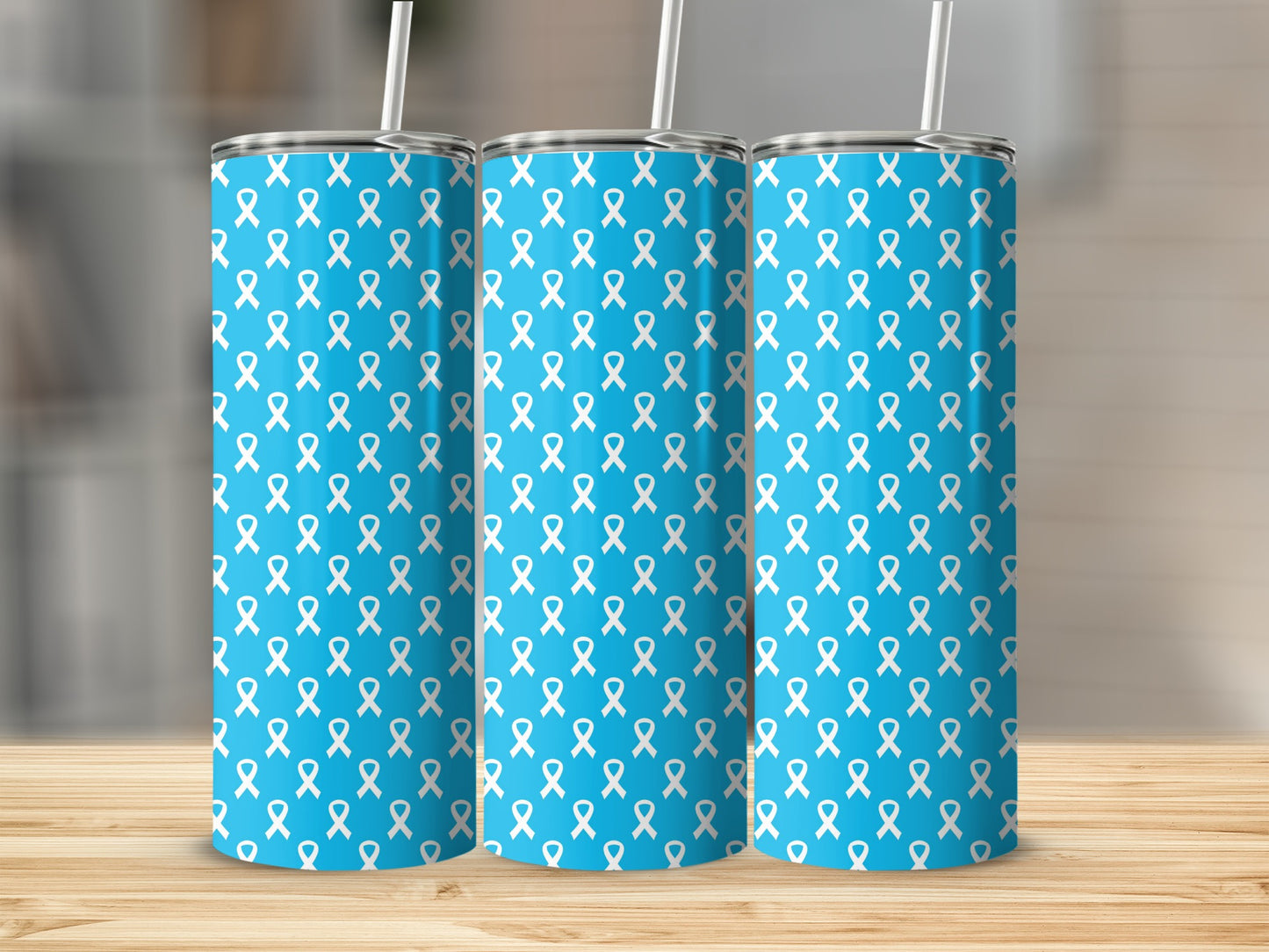 Three blue tumblers with a repeating white ribbon pattern and white straws.