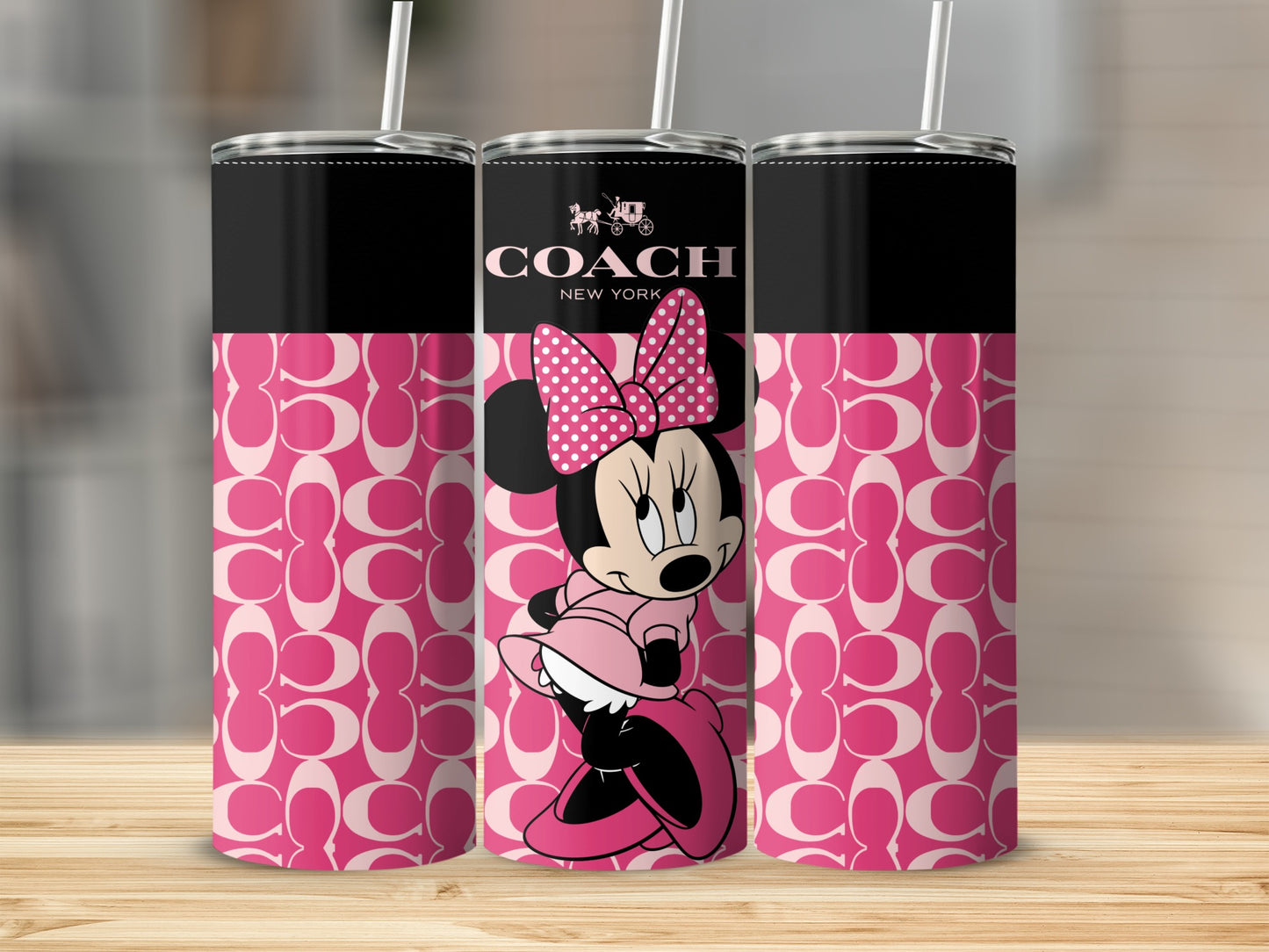 Three tumblers featuring Minnie Mouse and the Coach logo on a pink pattern.