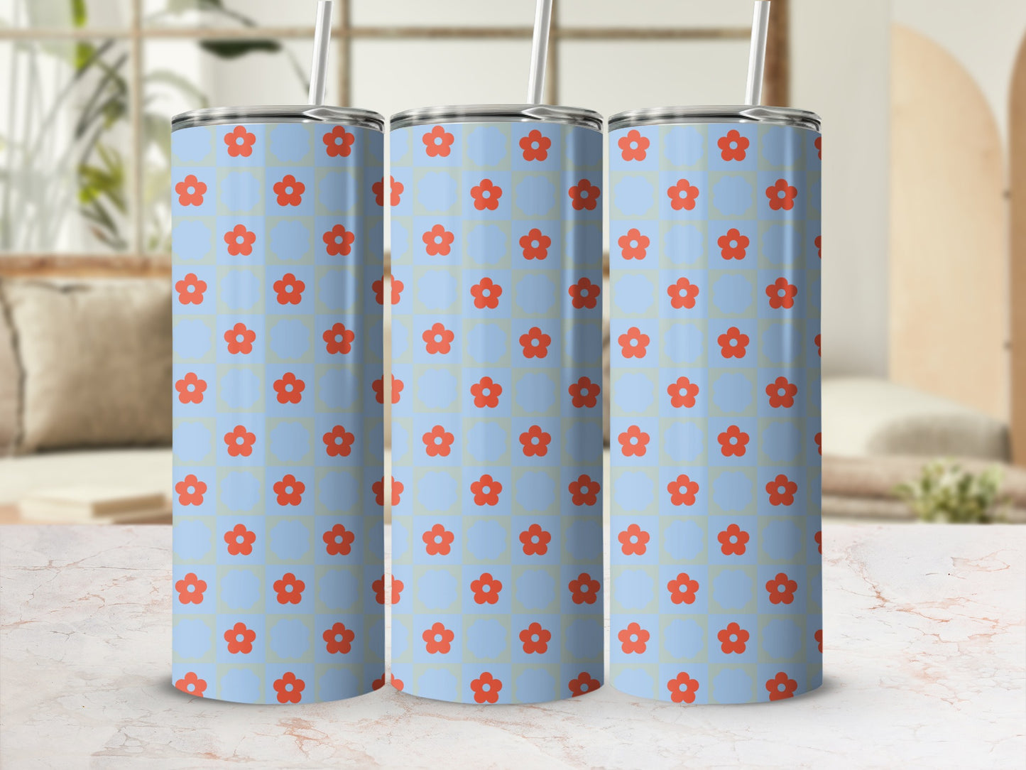 Three light blue tumblers with a red floral pattern and straws.
