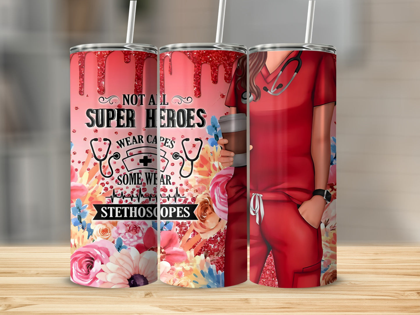 Red scrubs and stethoscope on a tumbler with "Not all heroes wear capes, some wear stethoscopes."