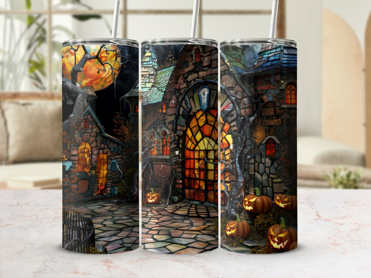 Haunted house with pumpkins and spooky moon scene on three tumblers.