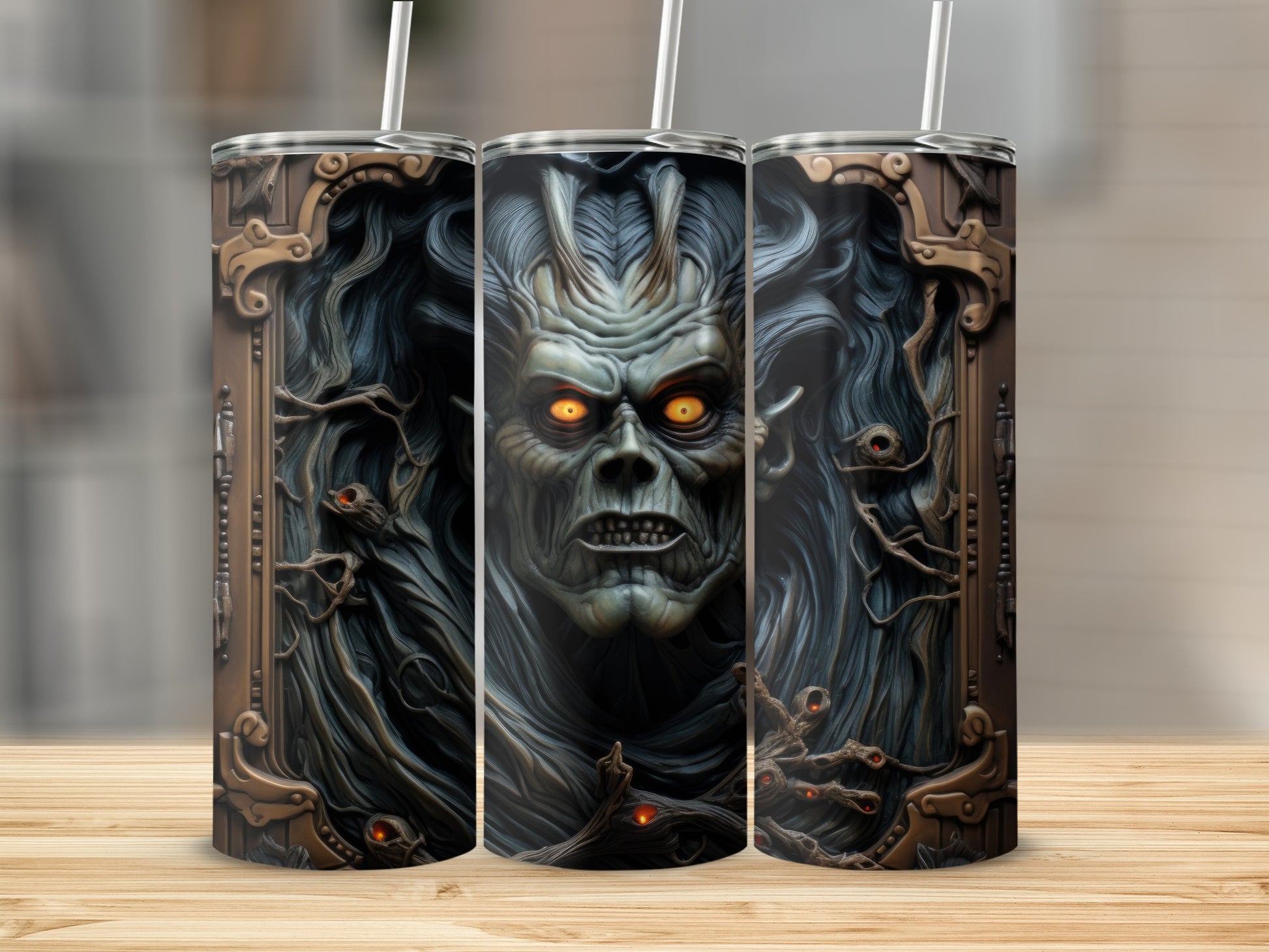 Three tumblers featuring a grotesque monster face with glowing orange eyes.