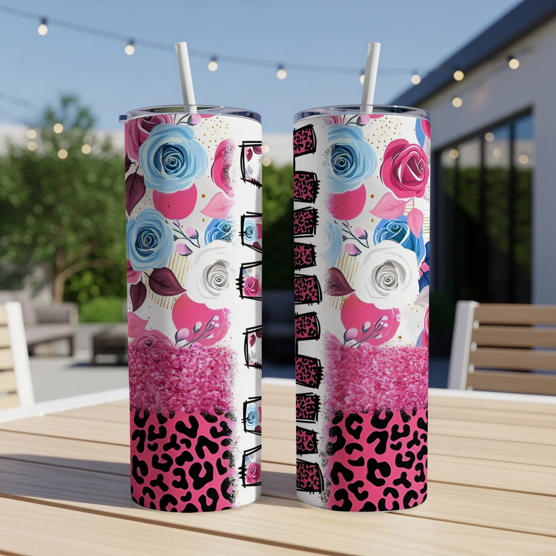 Two tumblers with floral and leopard print designs on a table.