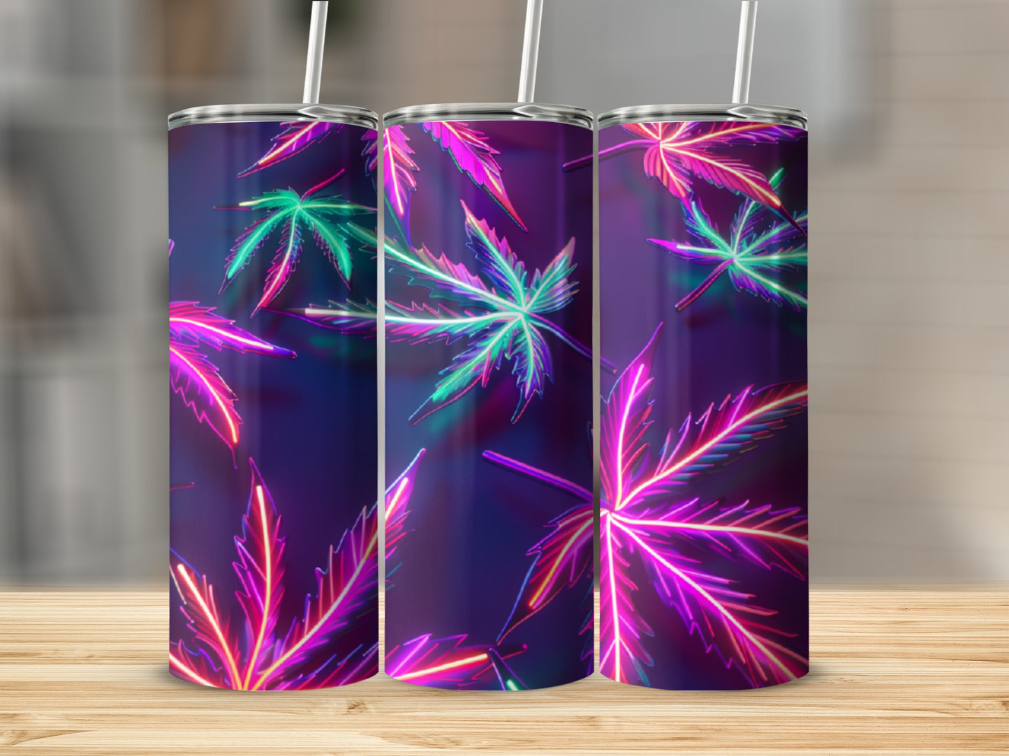 Three tumblers with neon cannabis leaf pattern on a wooden surface.