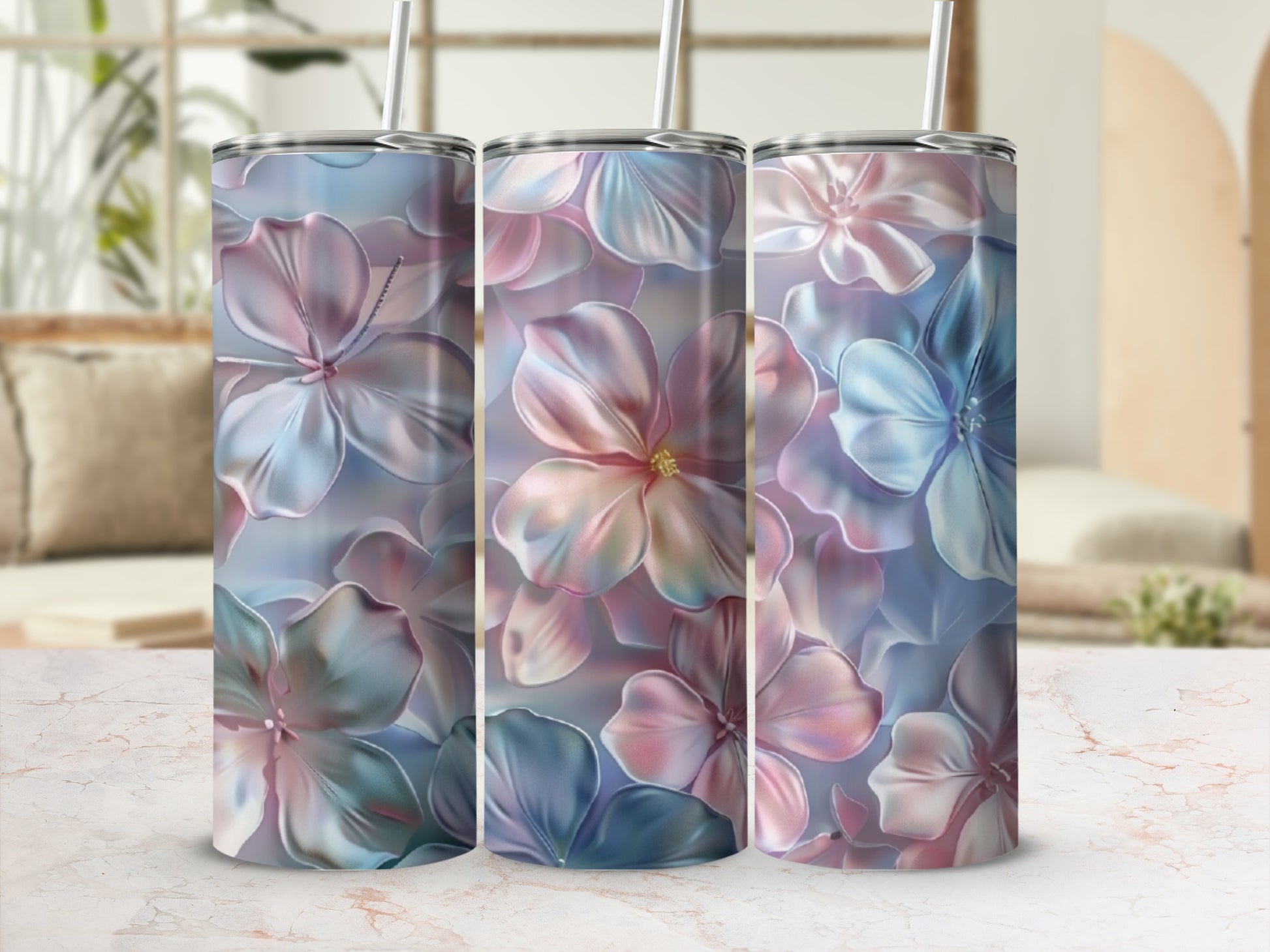 Three tumblers with a pastel floral design on a marble countertop.