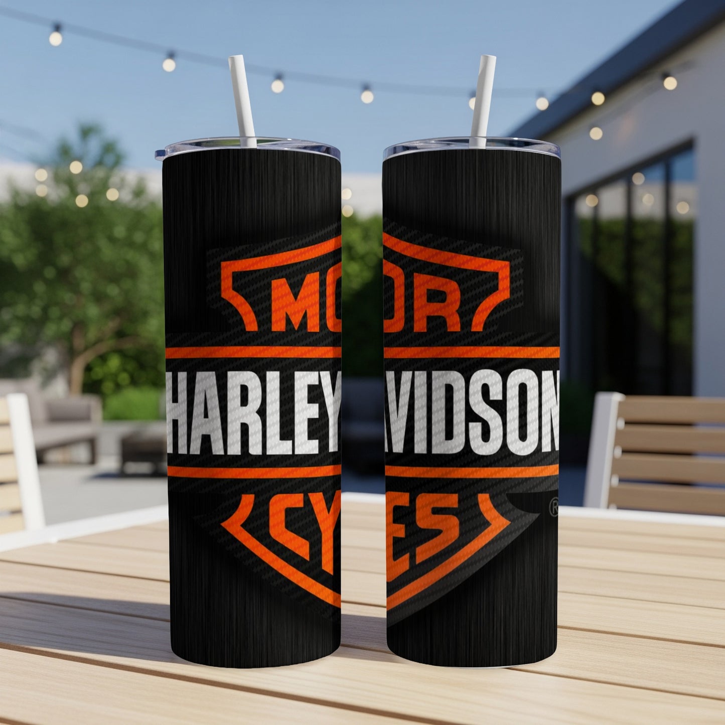 Two Harley Davidson tumblers with orange and white logo on a black surface.