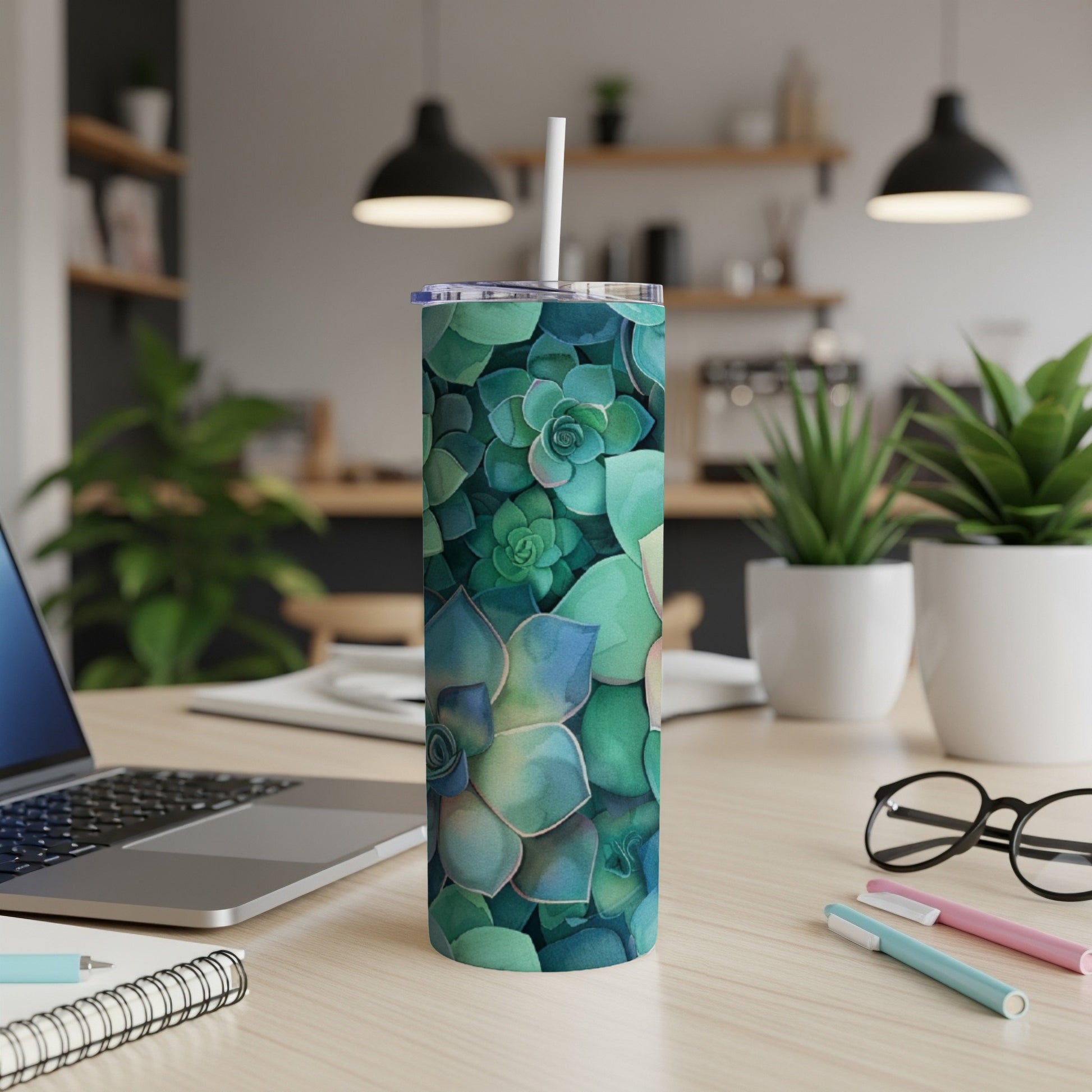 Green succulent pattern on a white skinny tumbler with a straw.