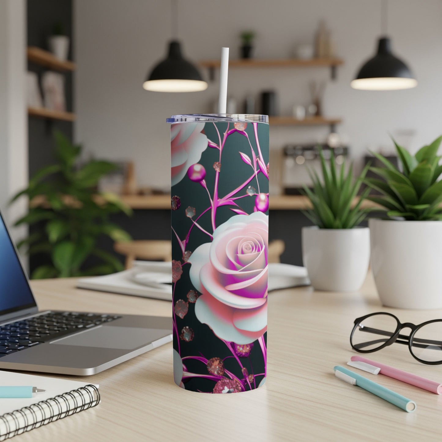 Pink and white rose floral pattern on a dark skinny tumbler with a white straw.
