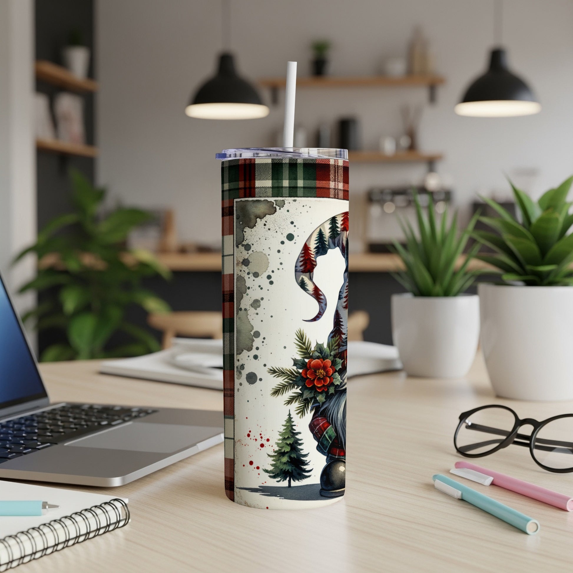 White tumbler with gnome, pine trees, and plaid pattern.