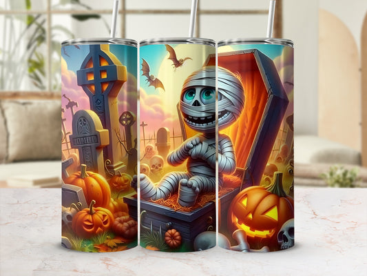 Halloween tumbler with mummy, pumpkins, skulls, and bats in a graveyard scene.
