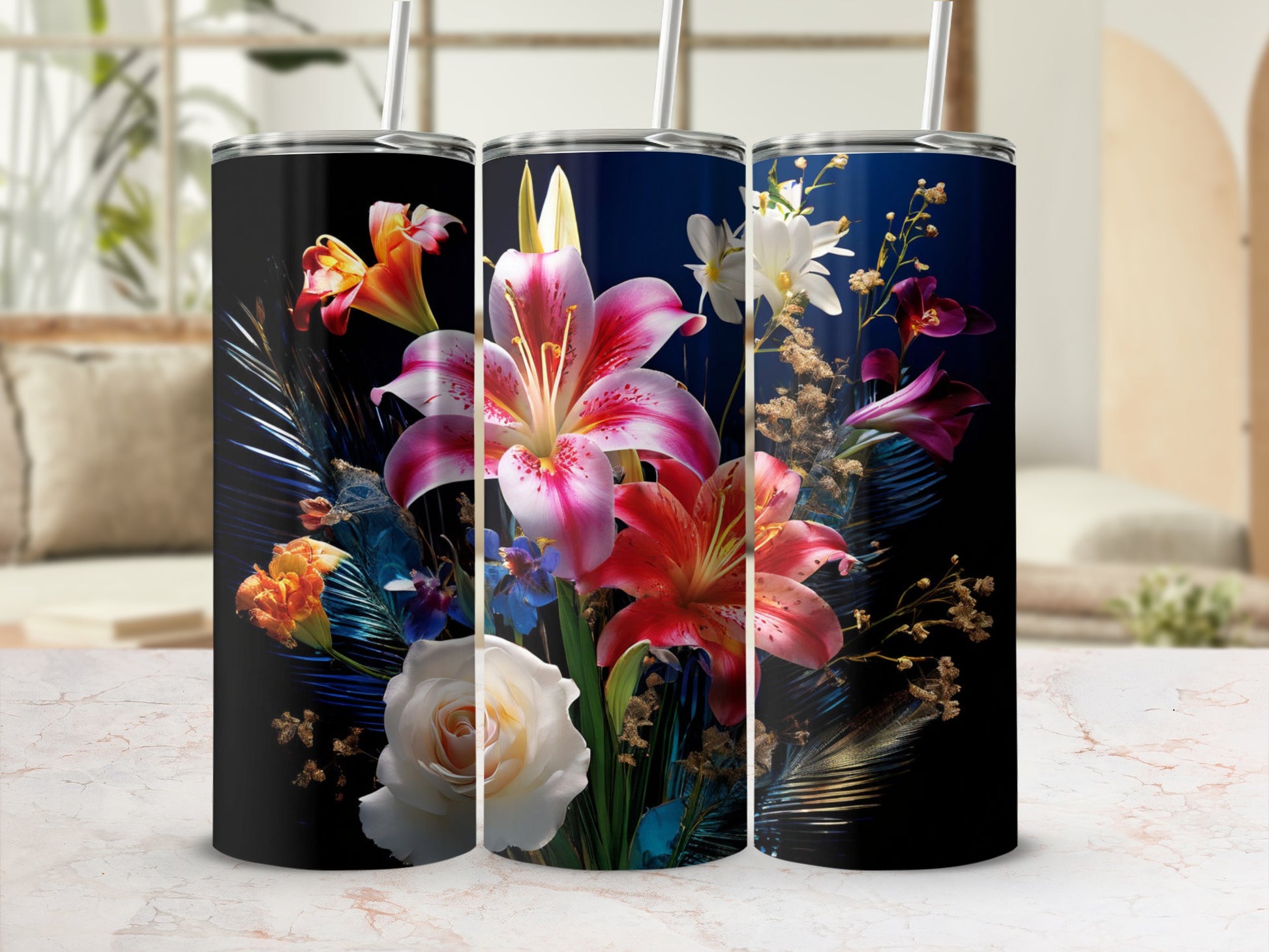 Three tumblers with floral designs on a counter.