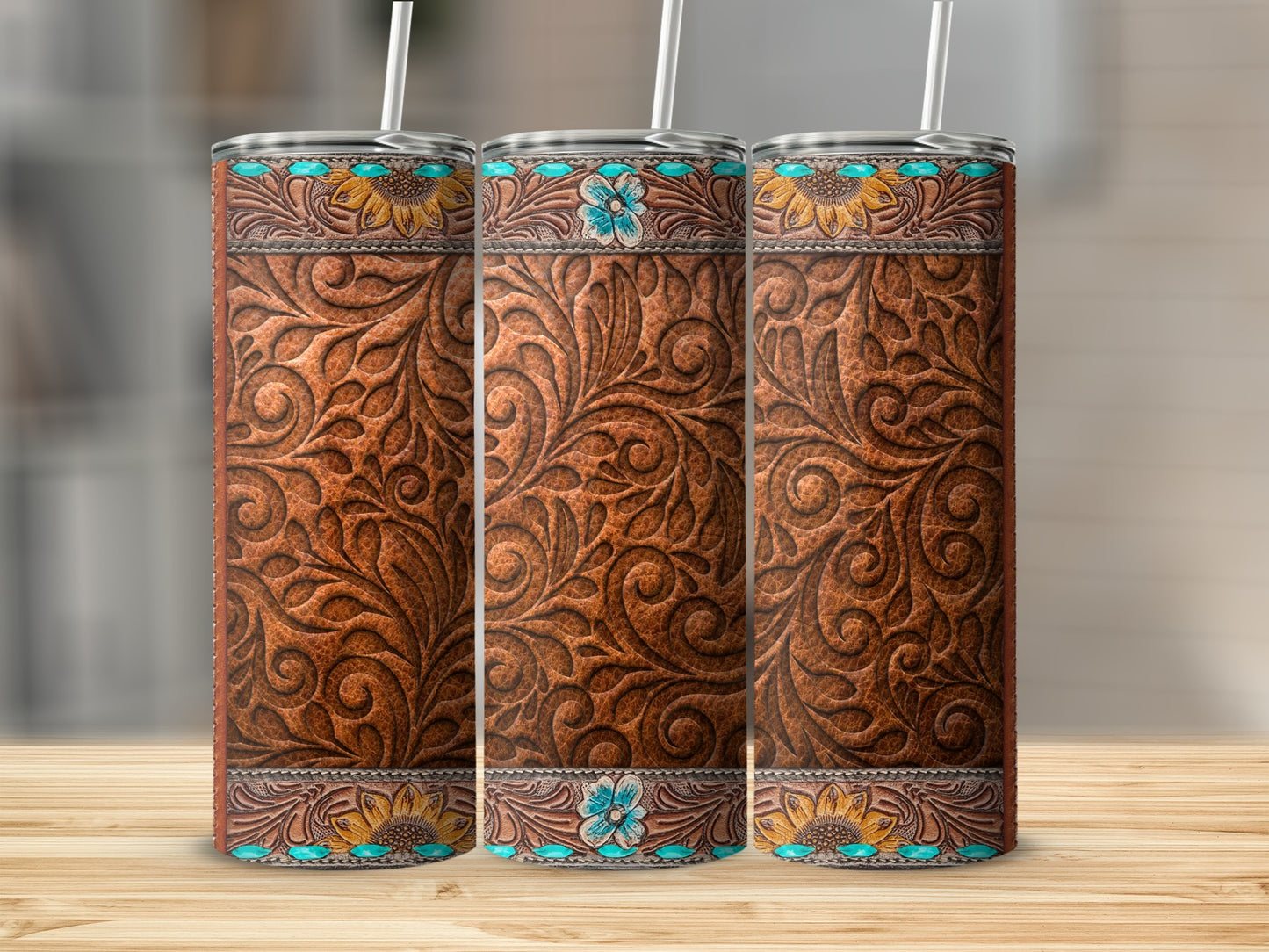 Three western-style tumblers with embossed leather and floral designs.