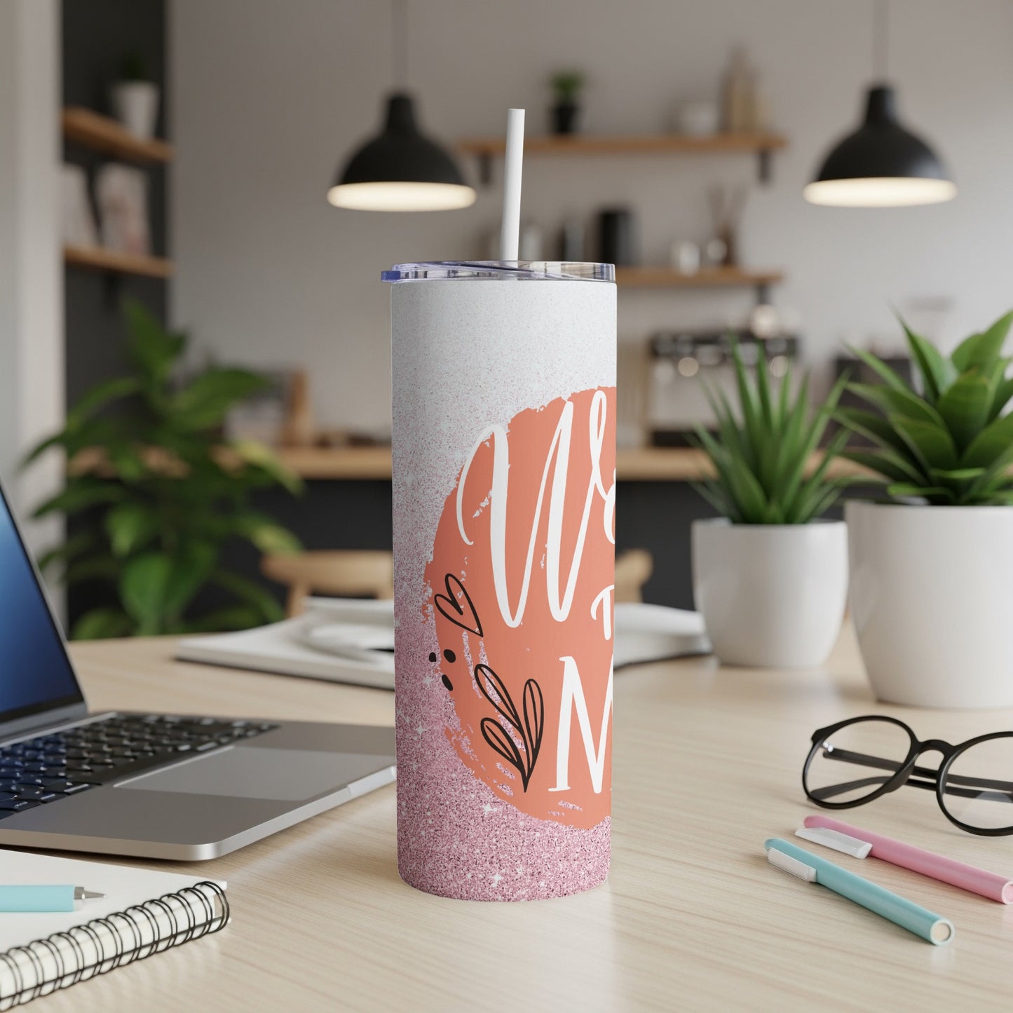 White tumbler with pink glitter and floral design reading "Mom".