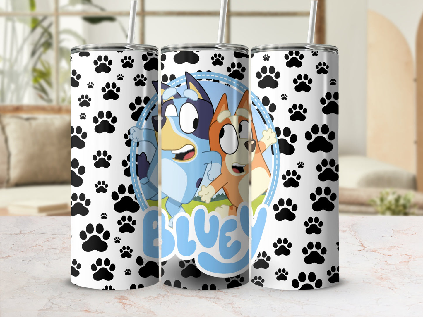 Bluey and Bingo characters on a white tumbler with paw print pattern.