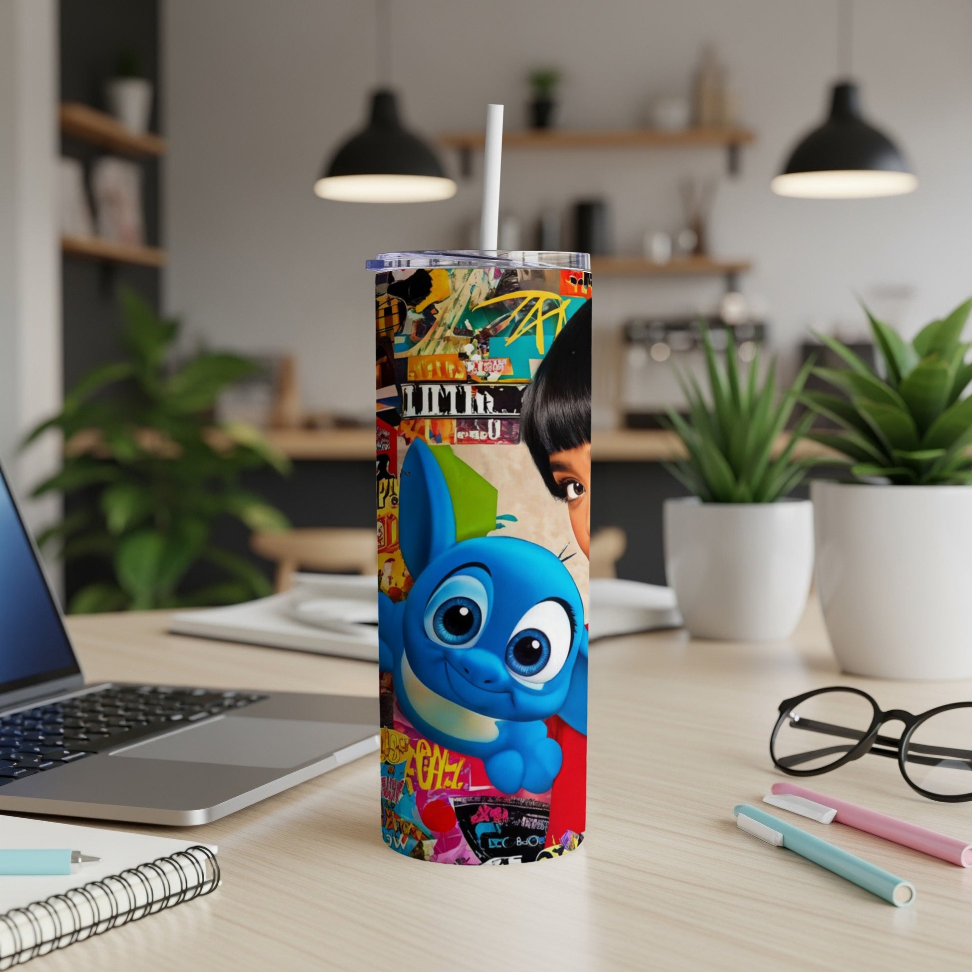 Blue alien character on a tumbler with a collage of colorful graffiti and pop culture images.