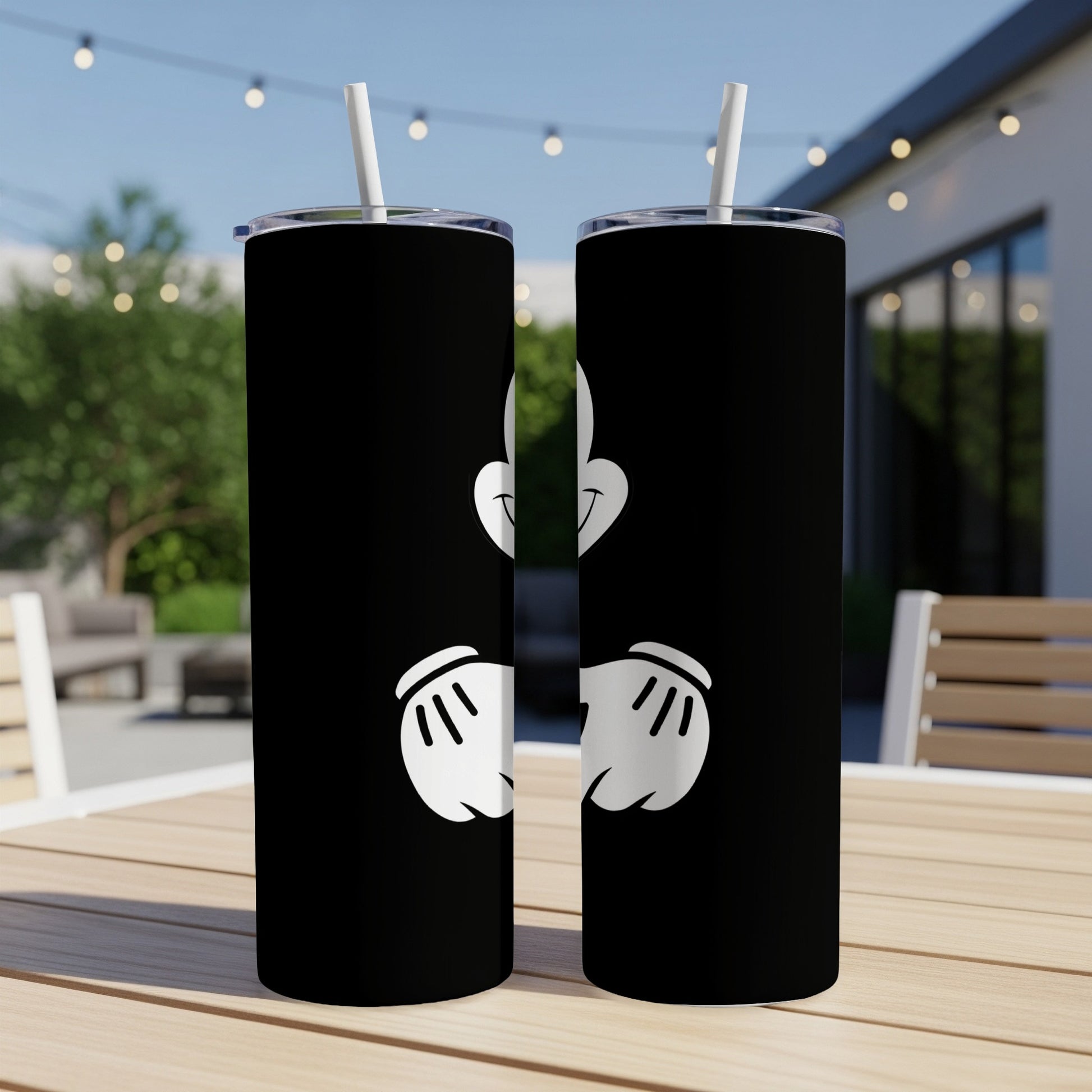 Two black tumblers with white cartoon hands giving a peace sign.