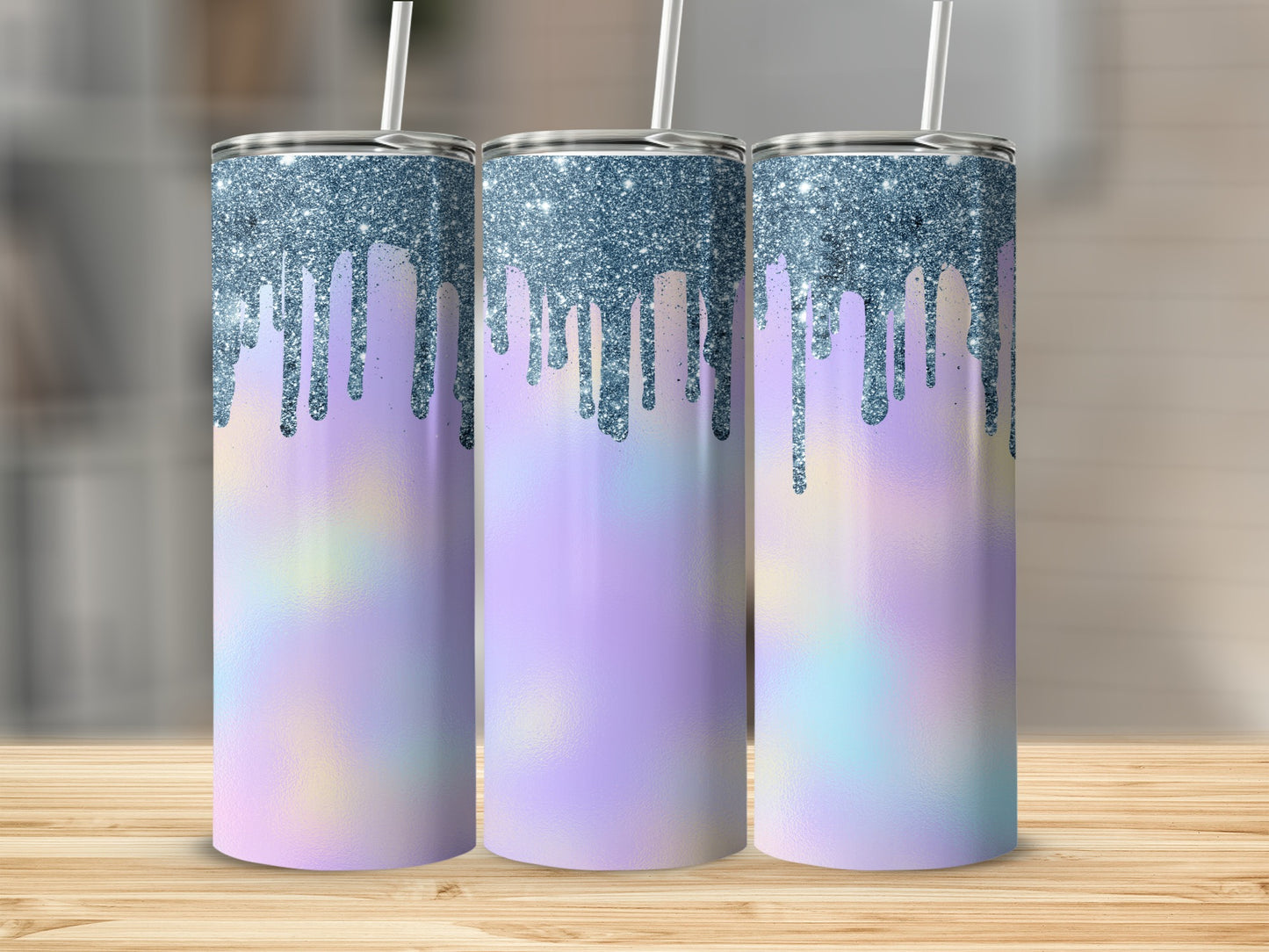 Three tumblers with pastel watercolor bases and blue glitter drip designs.