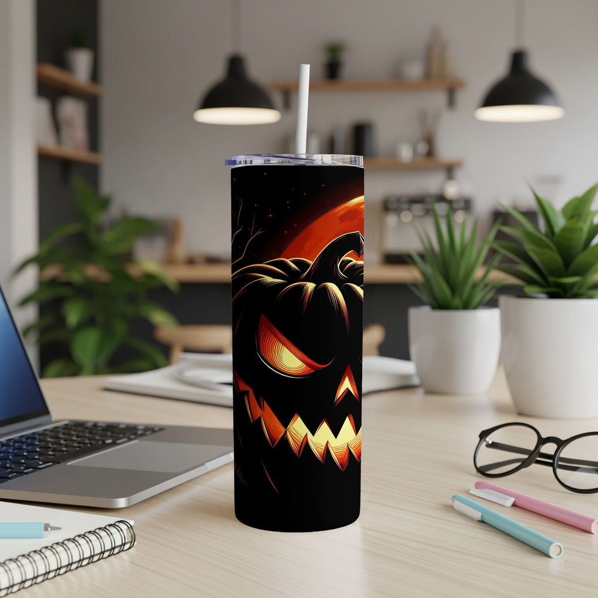 Black tumbler with a glowing jack-o'-lantern and orange moon design.