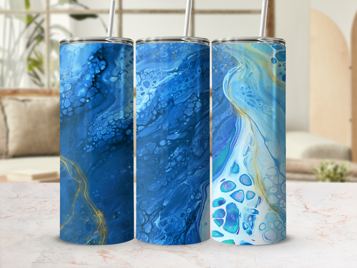 Three tumblers with abstract blue and gold fluid art designs.