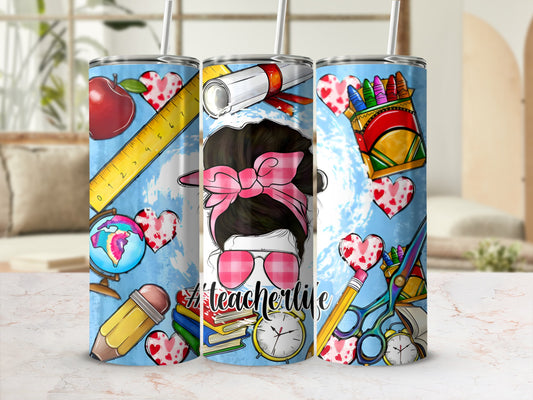 Teacher life tumbler with apple, globe, books, pencils, and scissors.