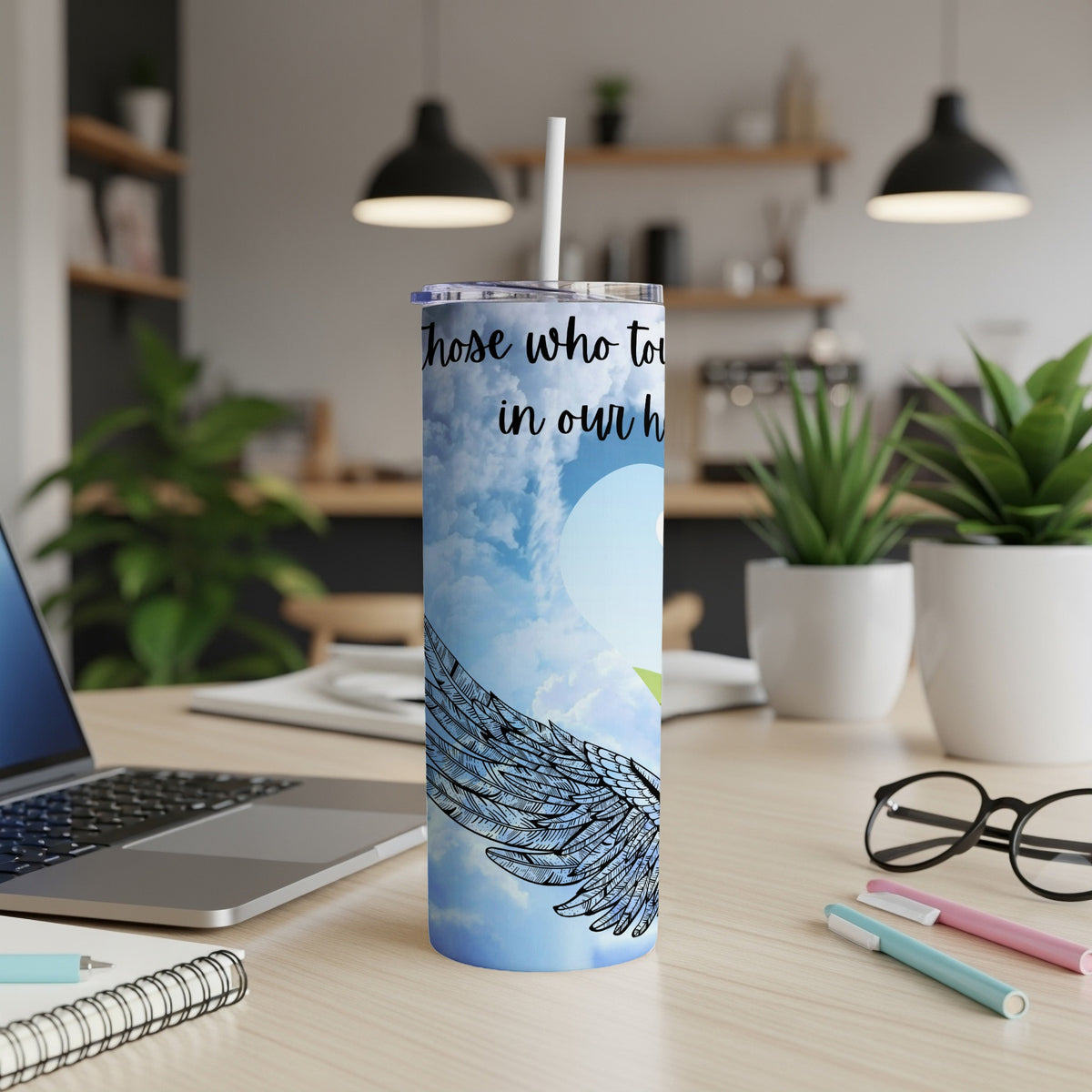 Tumbler with angel wings and text "Those who touch our hearts stay in our hearts forever".