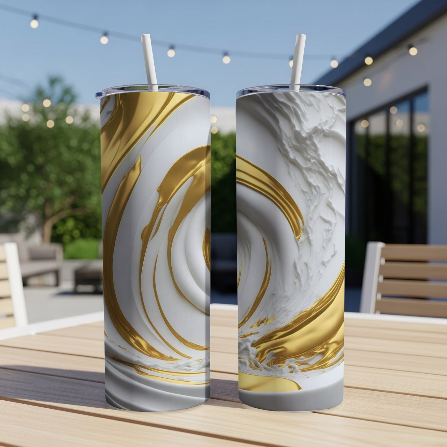 Two tall, white tumblers with swirling gold and white abstract patterns, with straws.