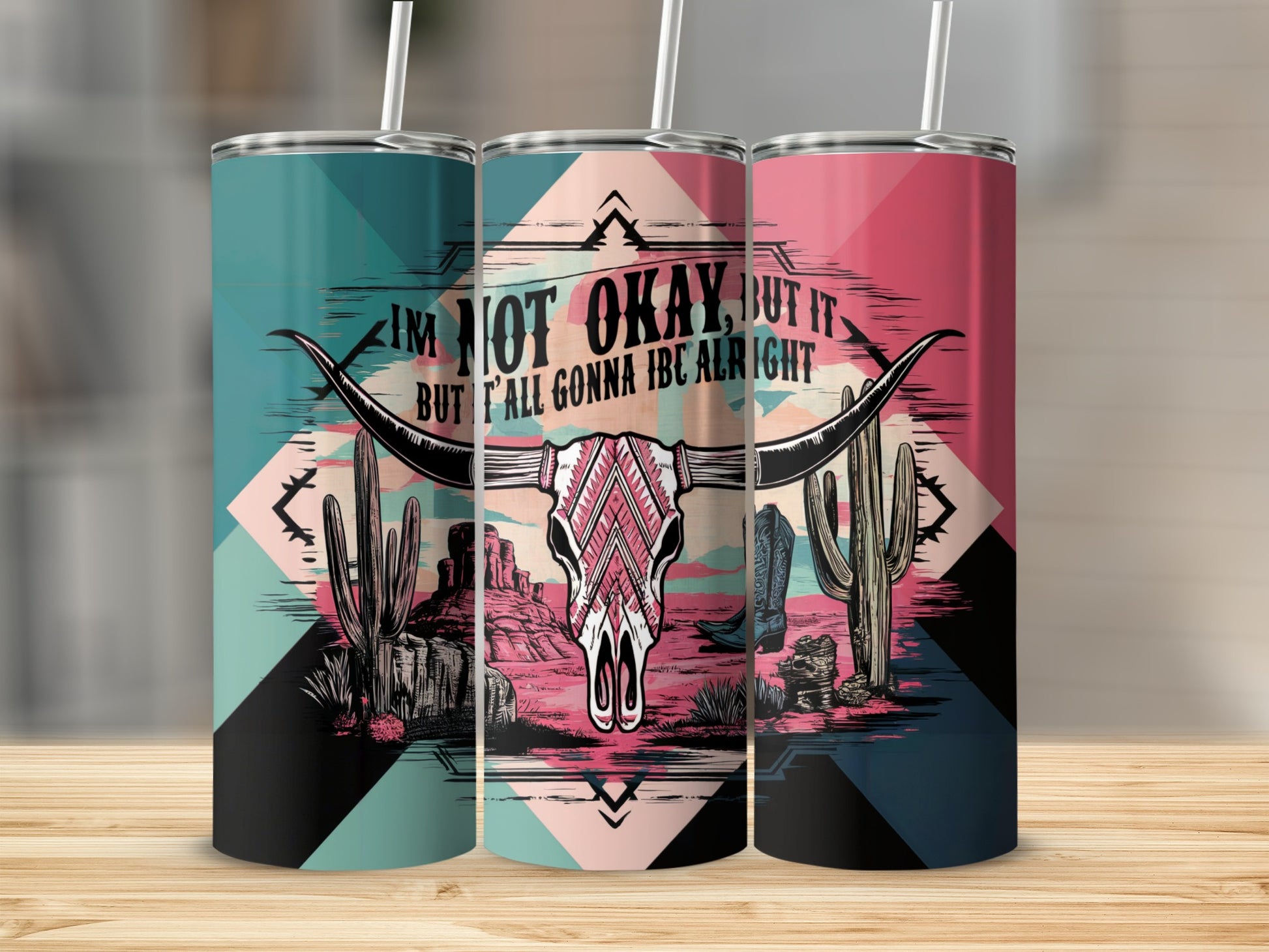 Tumbler with bull skull, cactus, cowboy boot, and text "I'm not okay, but it but t'all gonna be alright".